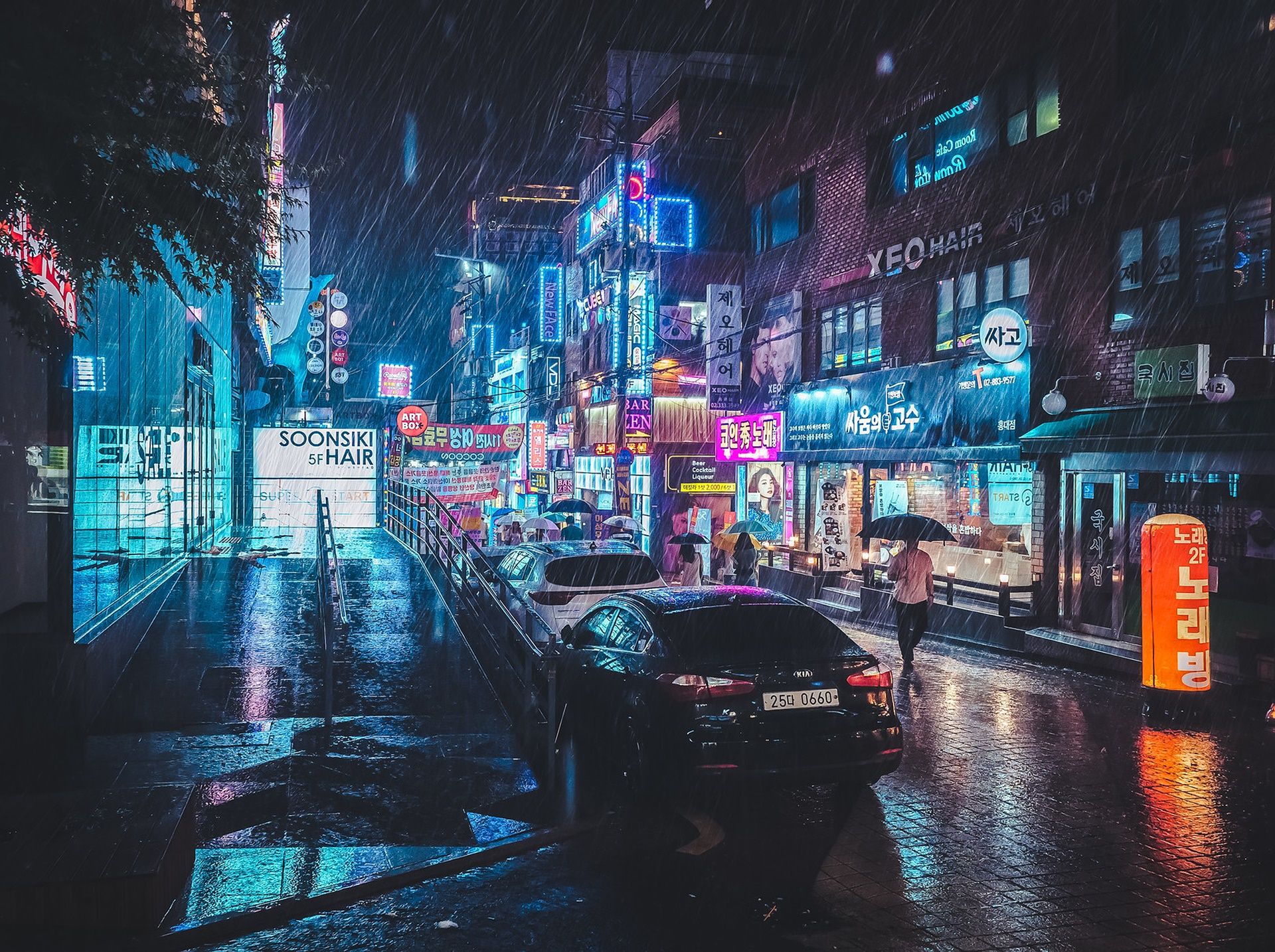 A rainy night in Seoul, South Korea, with neon lights illuminating the streets. - Seoul