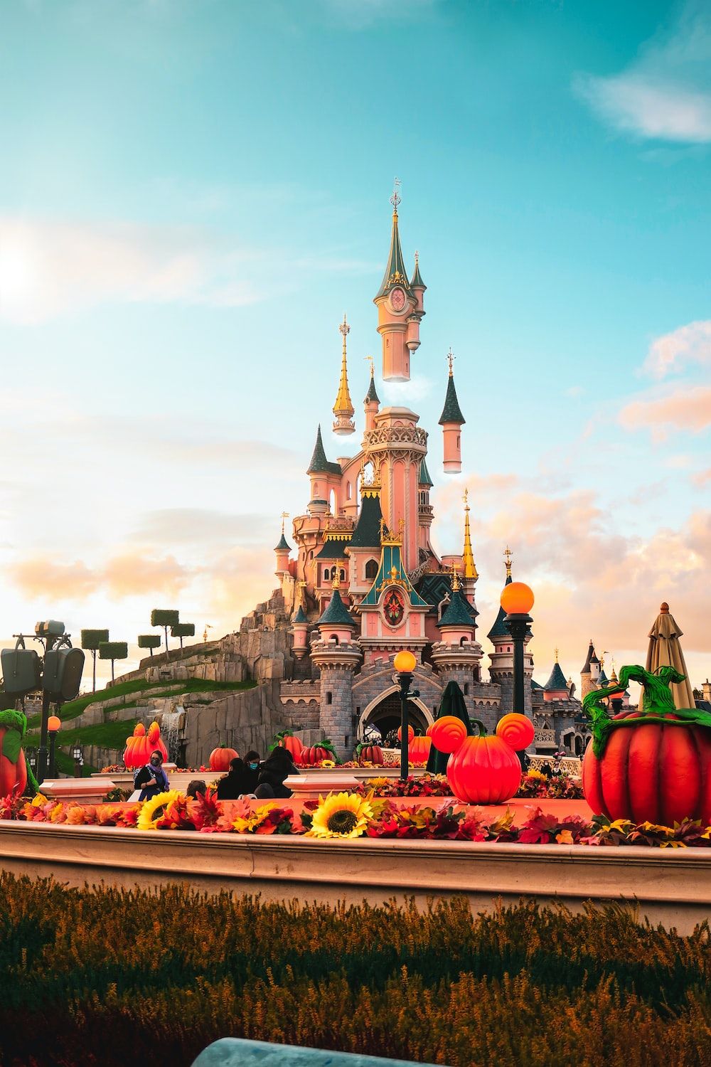 The castle is surrounded by flowers and pumpkins - Disneyland