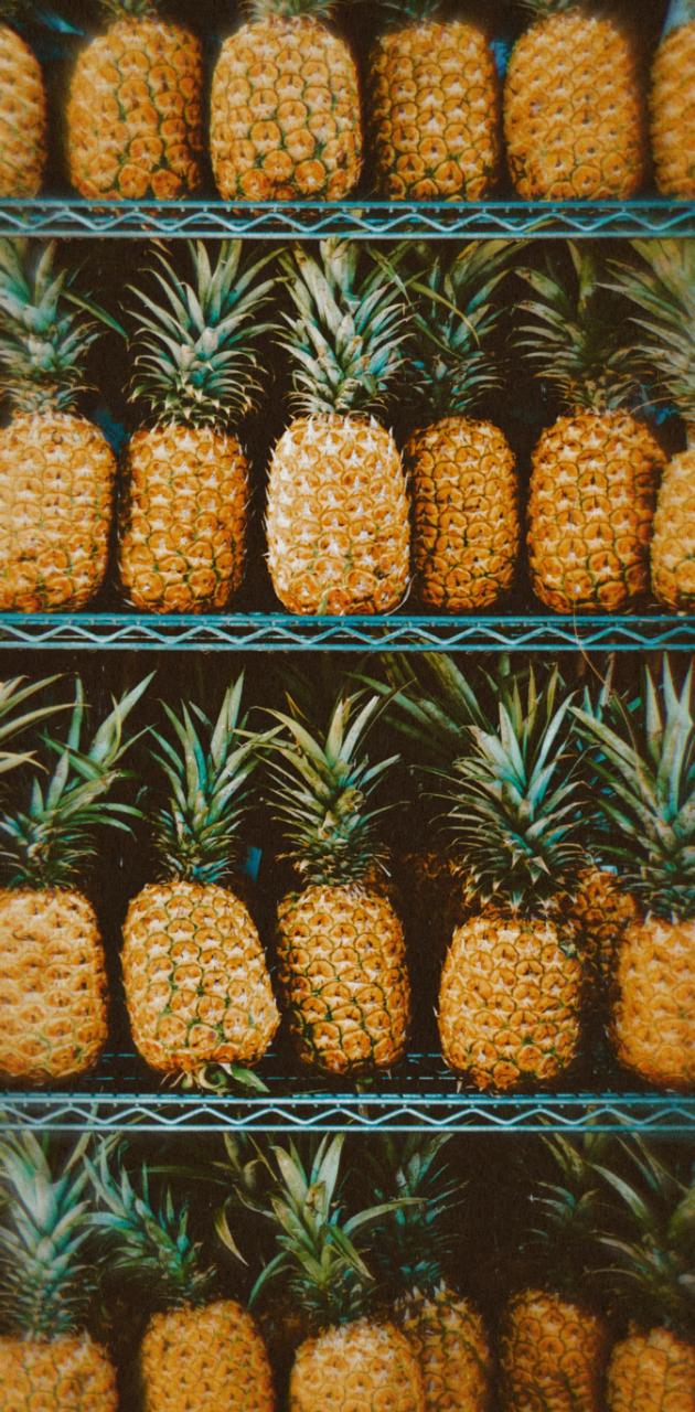 A bunch of pineapples on display in the store - Pineapple