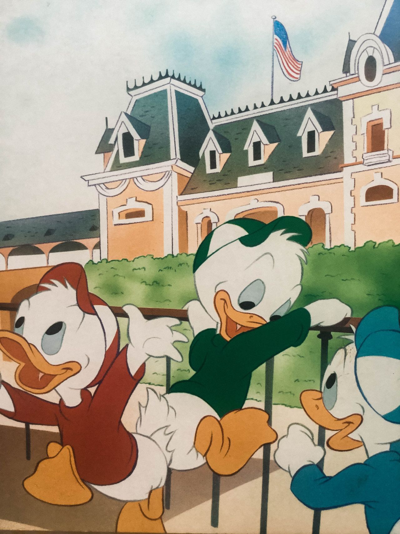 A cartoon of three ducks in front - Disneyland