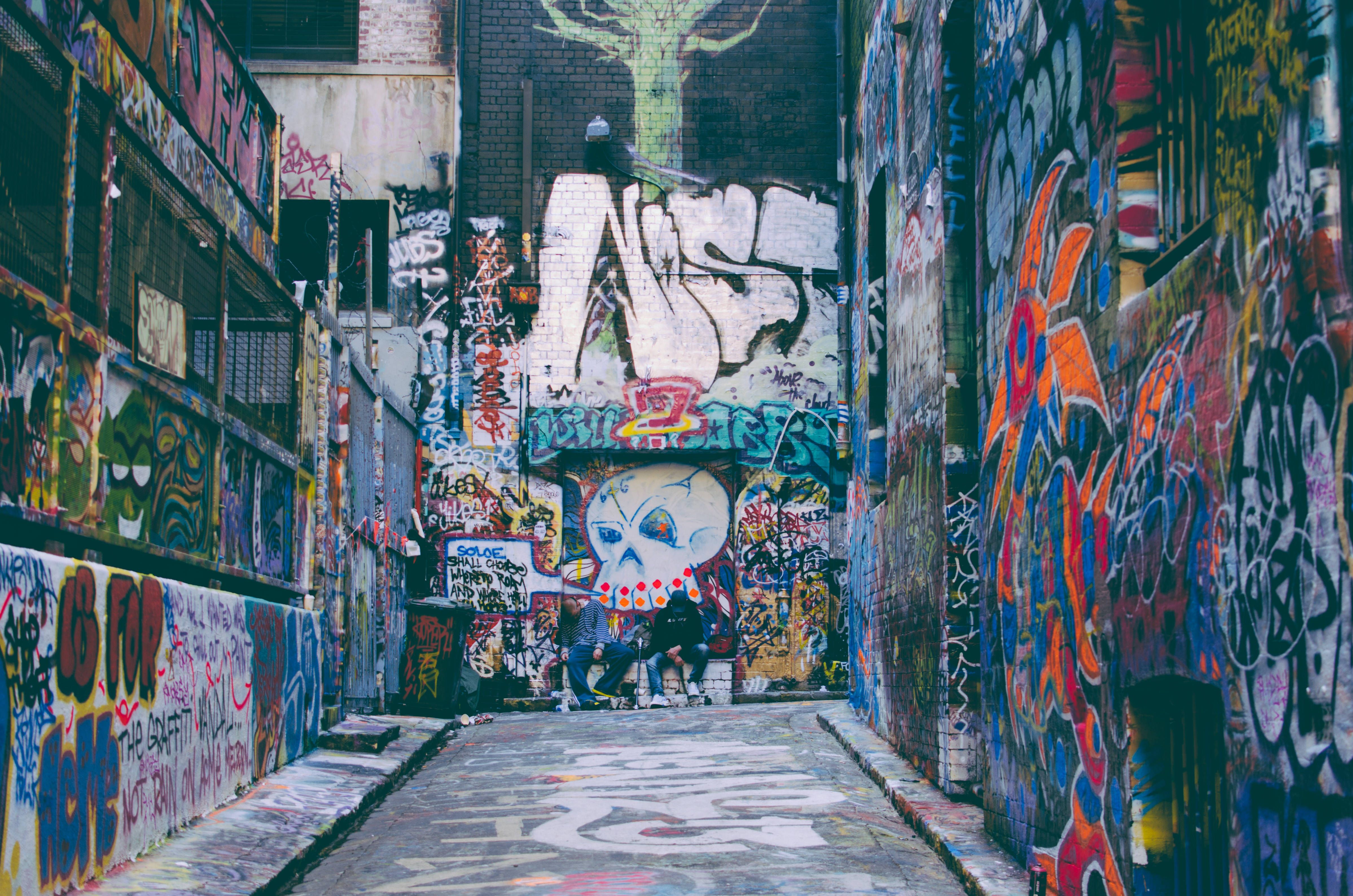 A street with graffiti on the walls - Graffiti, street art