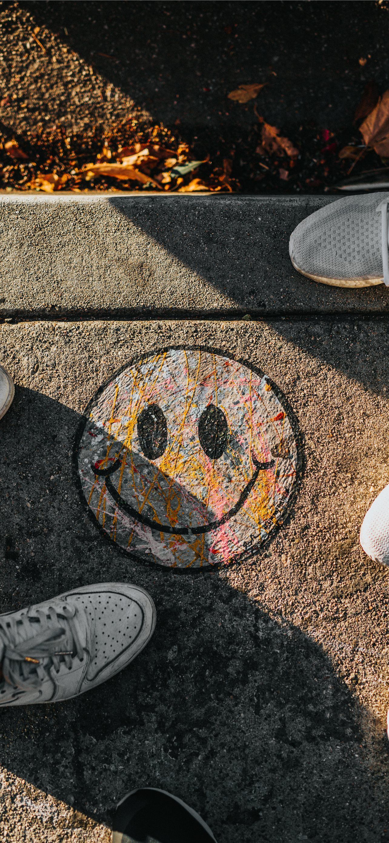 A group of people standing around some shoes - Graffiti