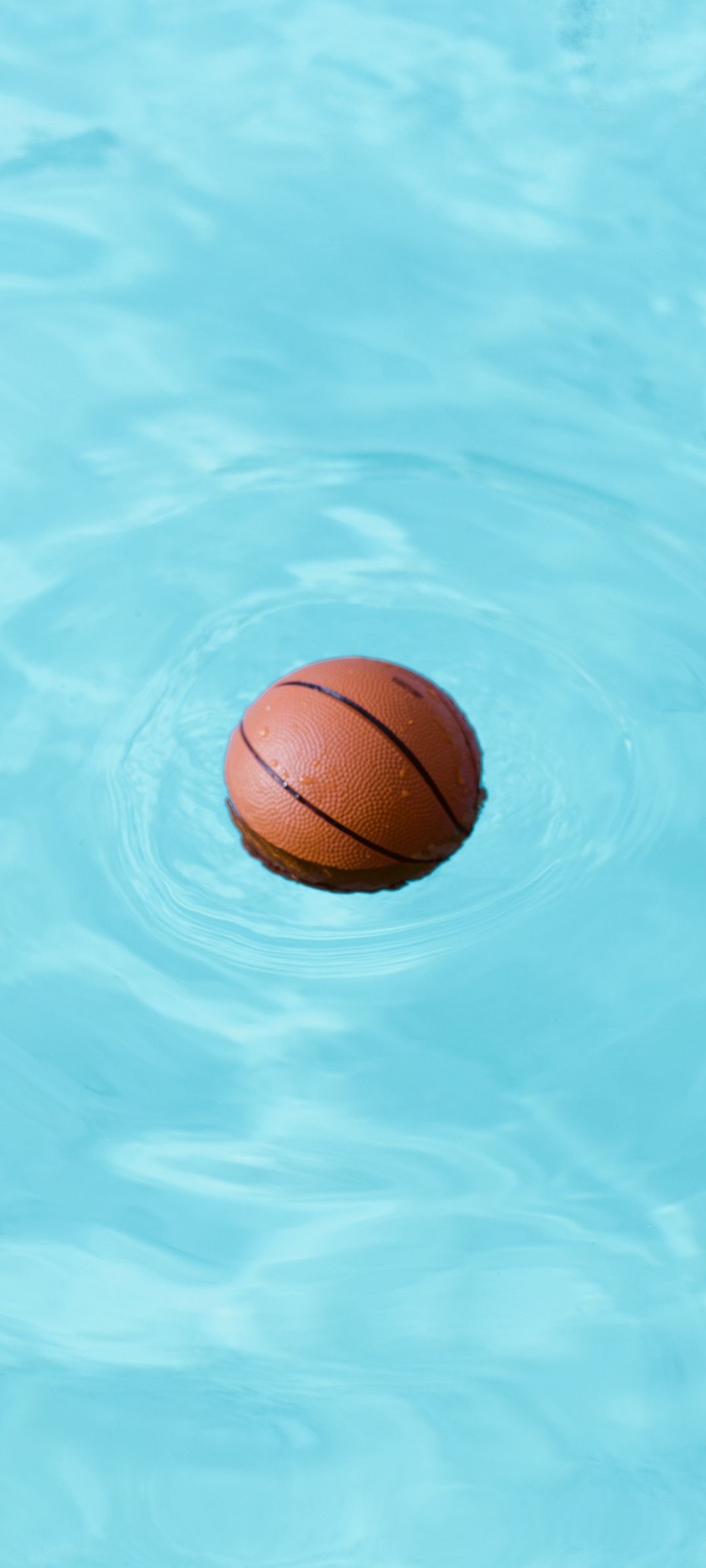 A basketball floating in the water - Basketball