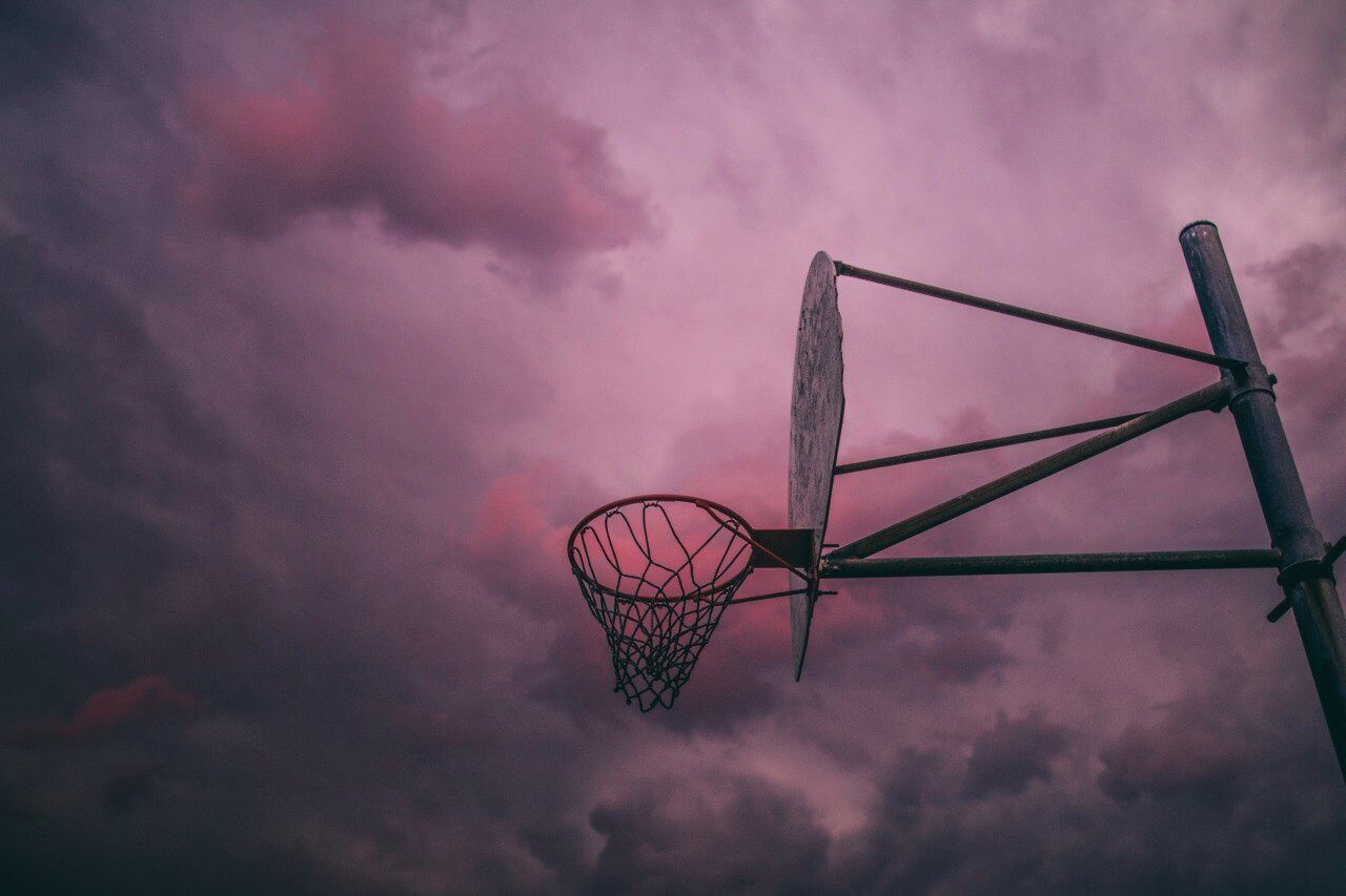 A basketball hoop is underneath the sky - Basketball