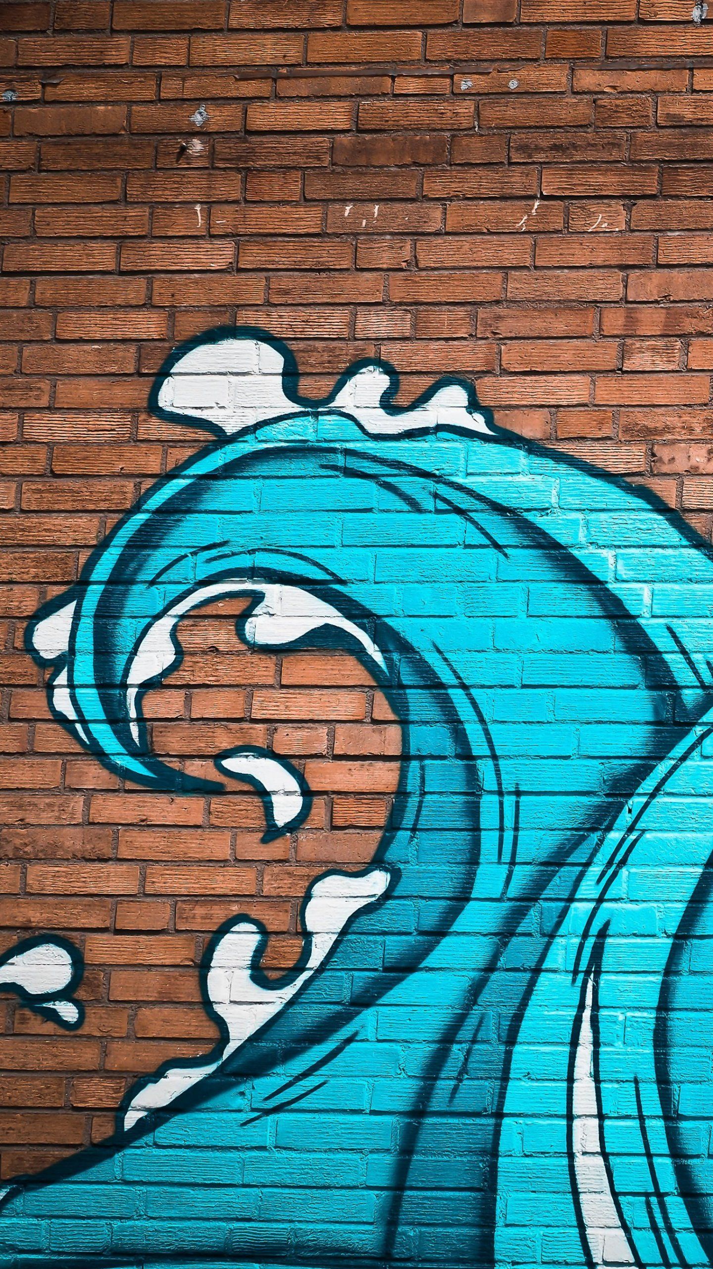 IPhone wallpaper of a brick wall with a blue wave painted on it - Graffiti