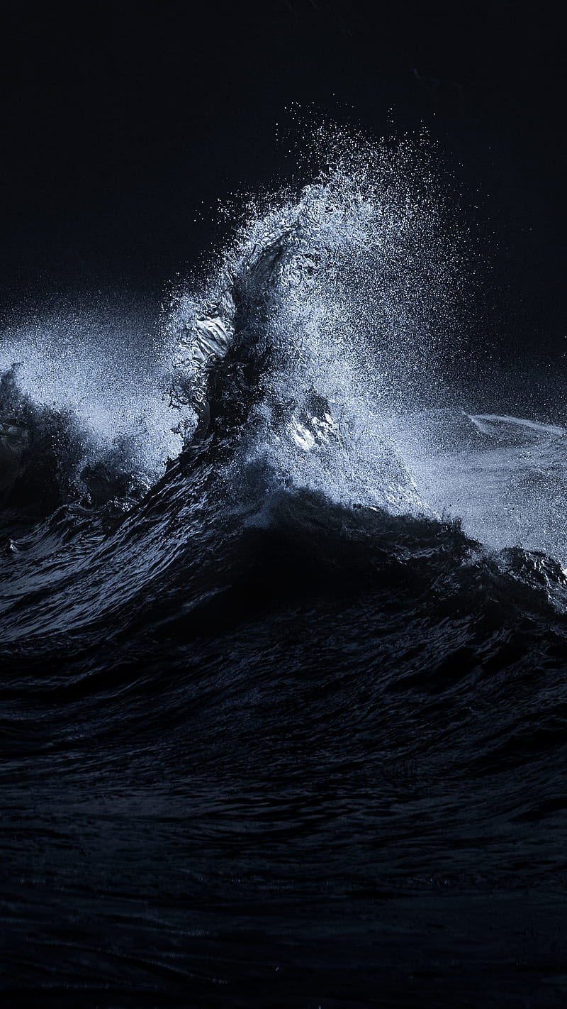 A wave in the ocean with a dark background - Wave
