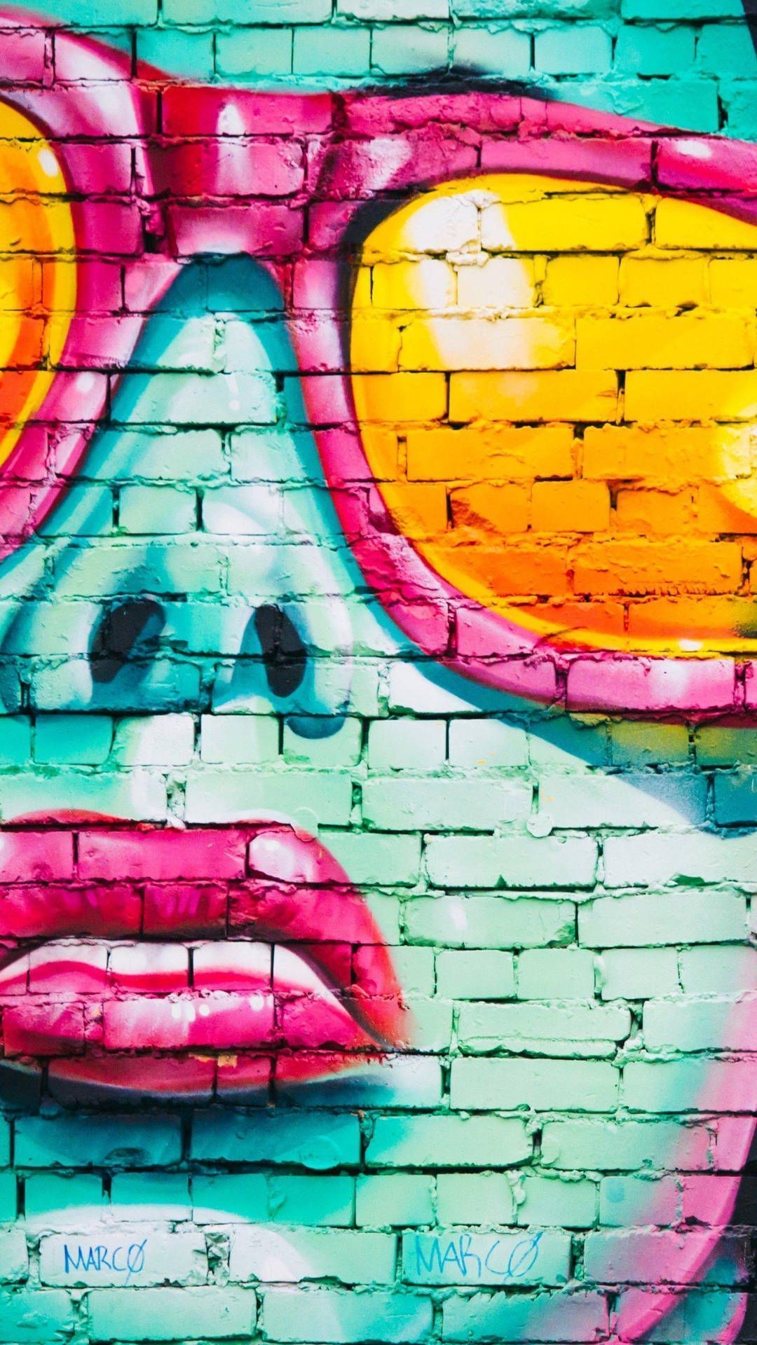 IPhone wallpaper with graffiti art of a face with sunglasses on a brick wall - Graffiti