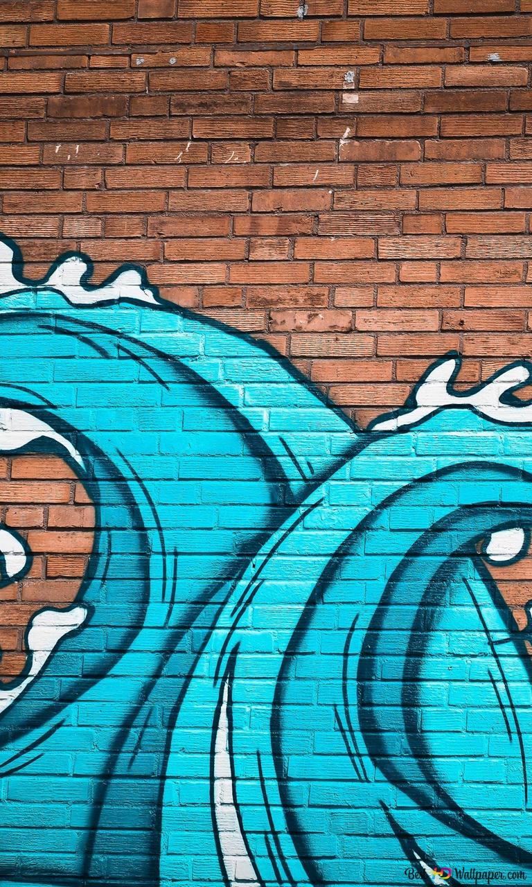 A blue wave is painted on the side of brick wall - Graffiti