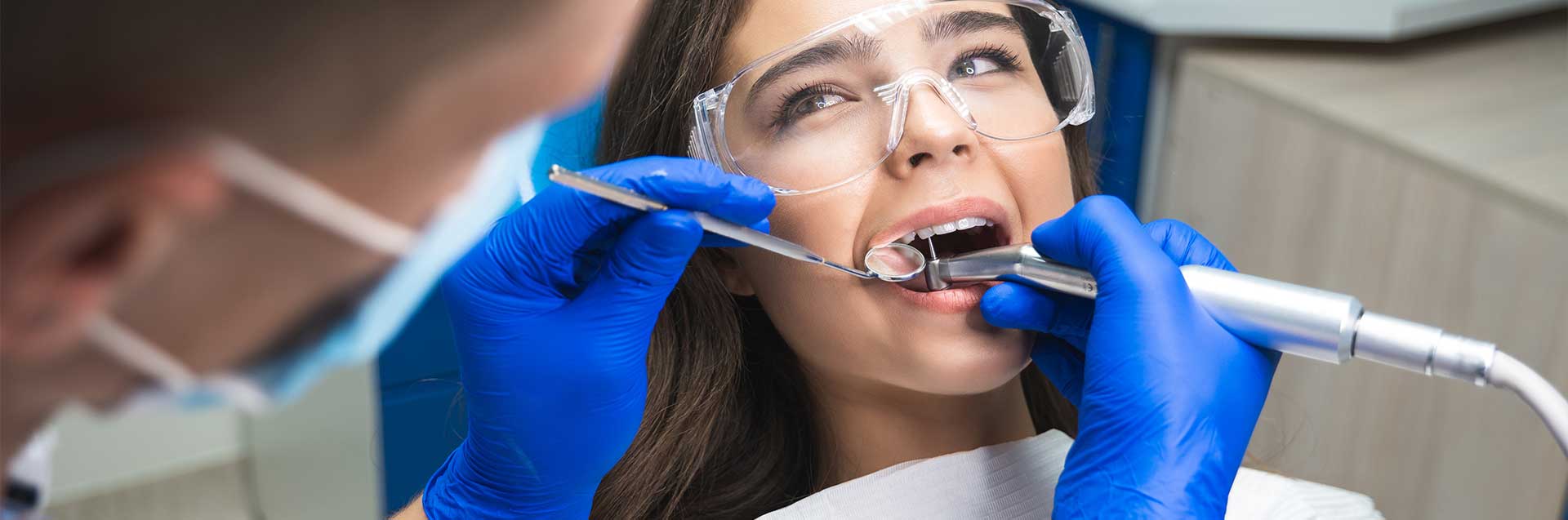 A dentist examining the teeth of an adult - Dentist