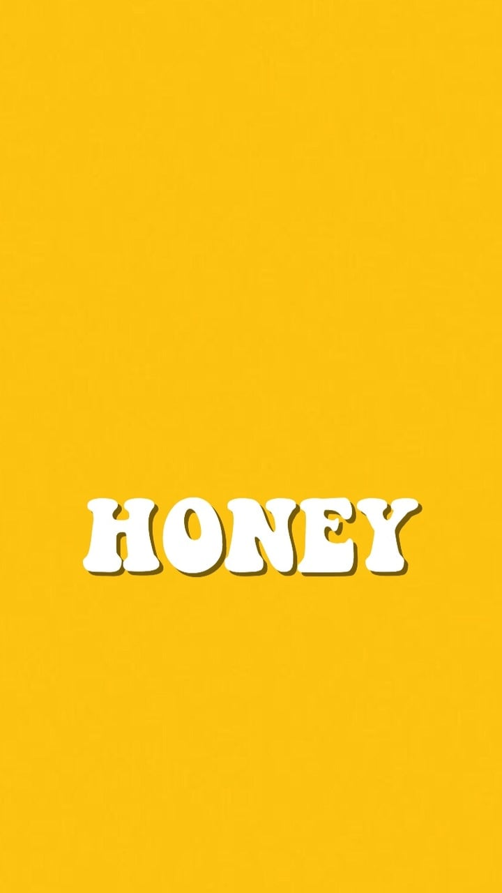 A yellow background with the word honey in white letters - Honey