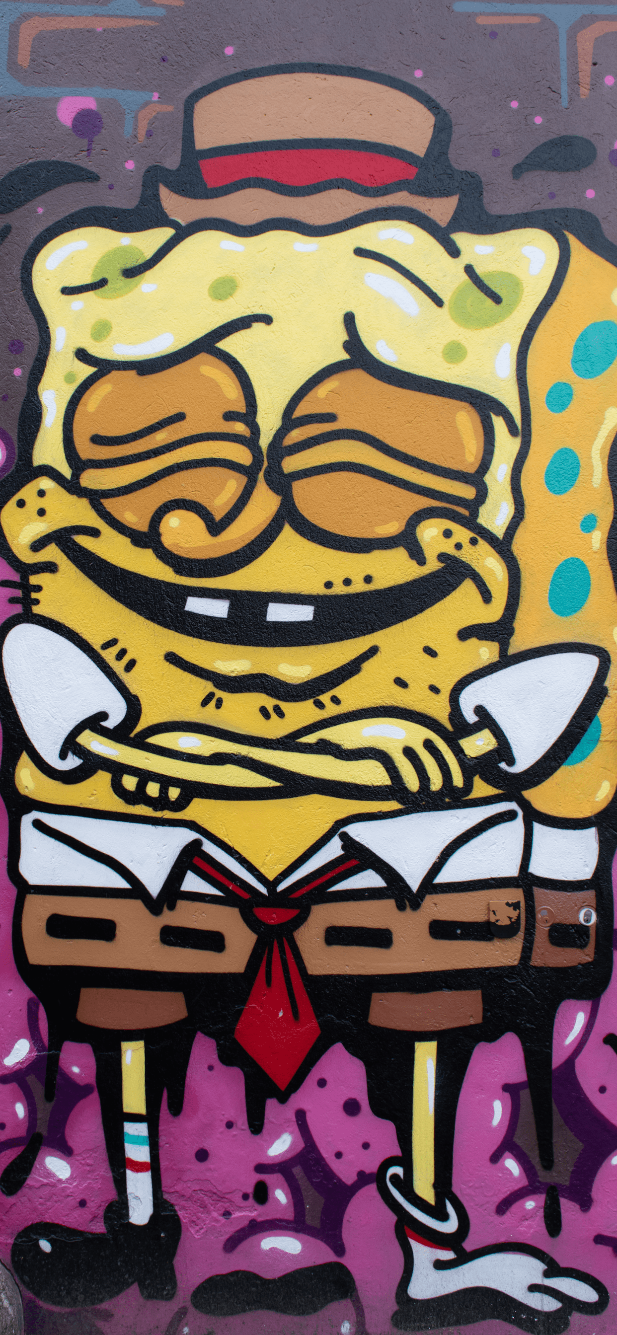 A graffiti painting of SpongeBob SquarePants wearing a hat and a red tie. - Graffiti