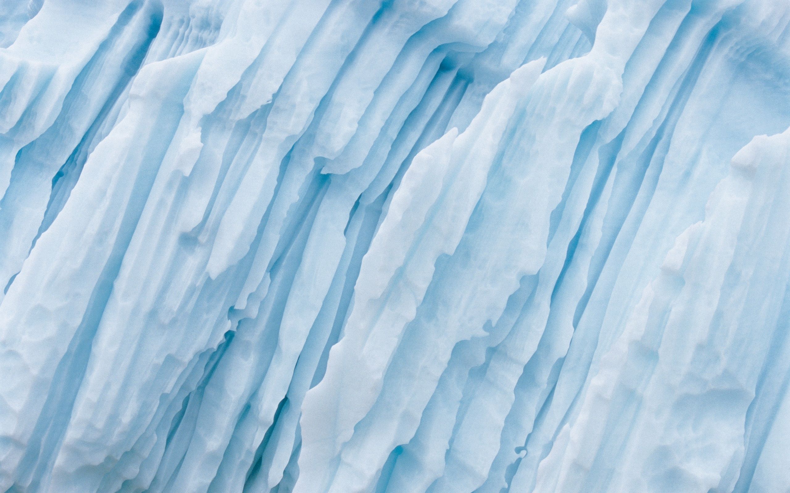 A close-up of a blue and white ice formation. - Ice