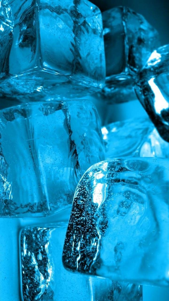 A close up of ice cubes in blue light - Ice