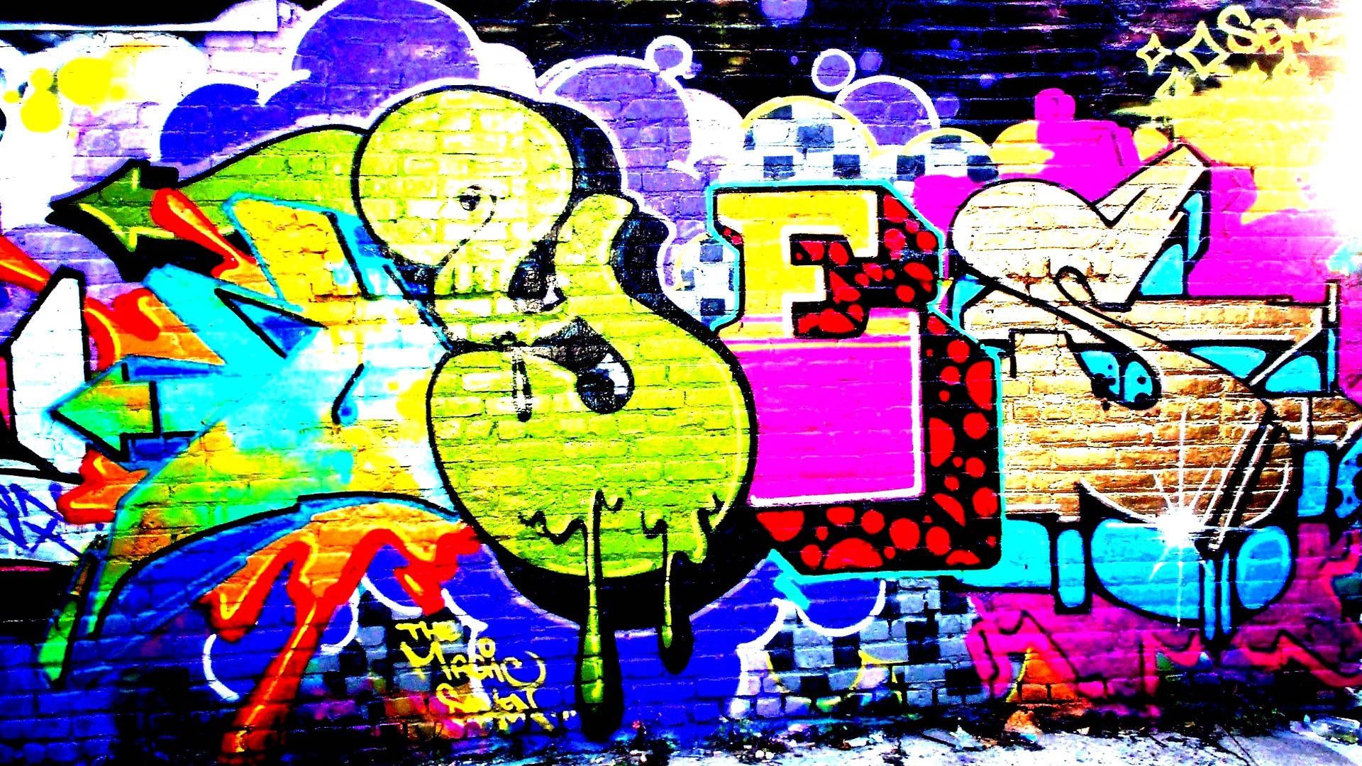 A colorful graffiti wall with the word love on it - Graffiti