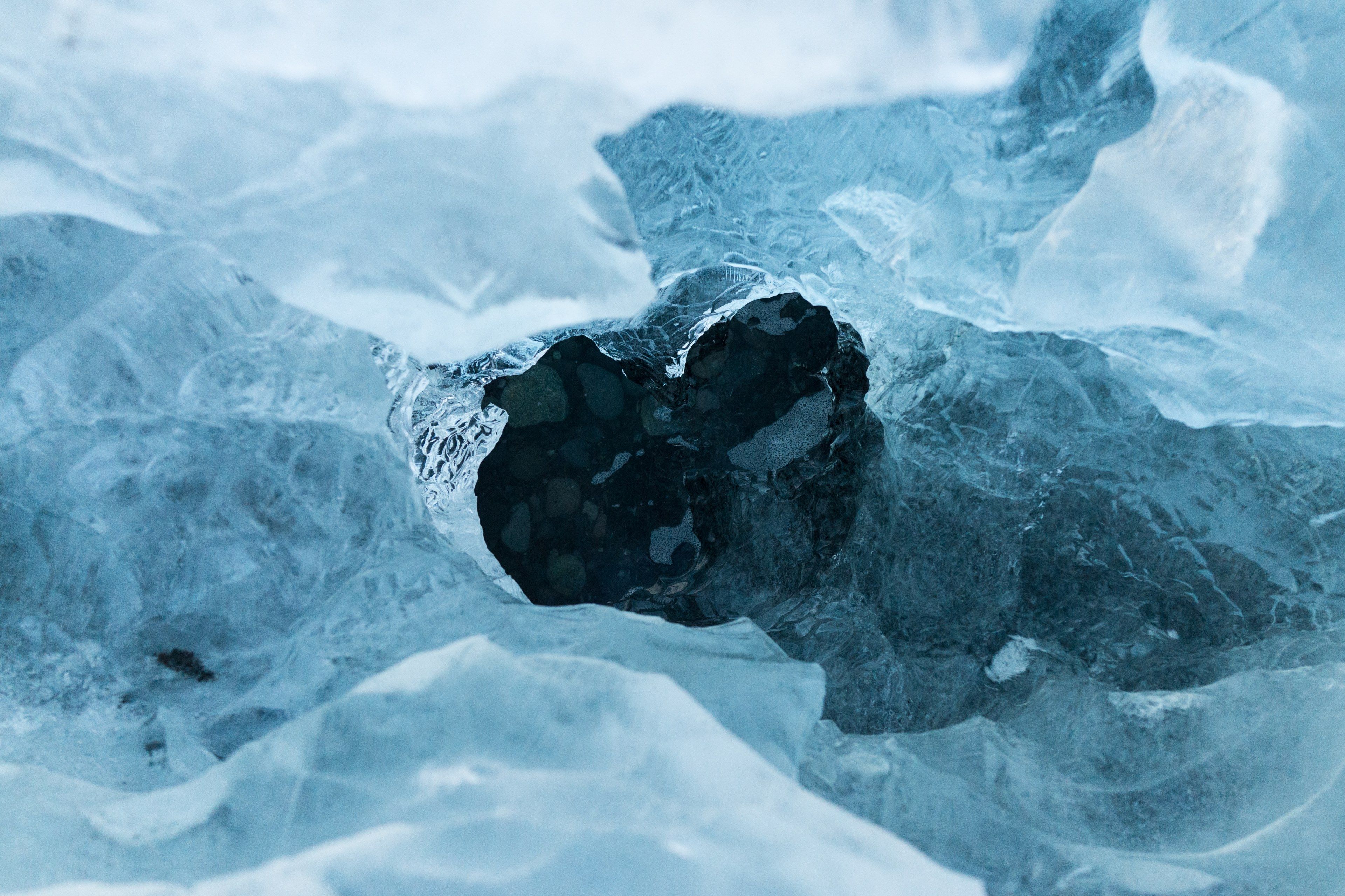 Wallpaper / a hole in an ice sheet covering dark blue water, shattered ice over water 4k wallpaper free download