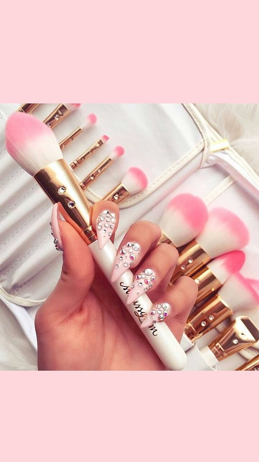 A set of makeup brushes with a pink and white design - Nails