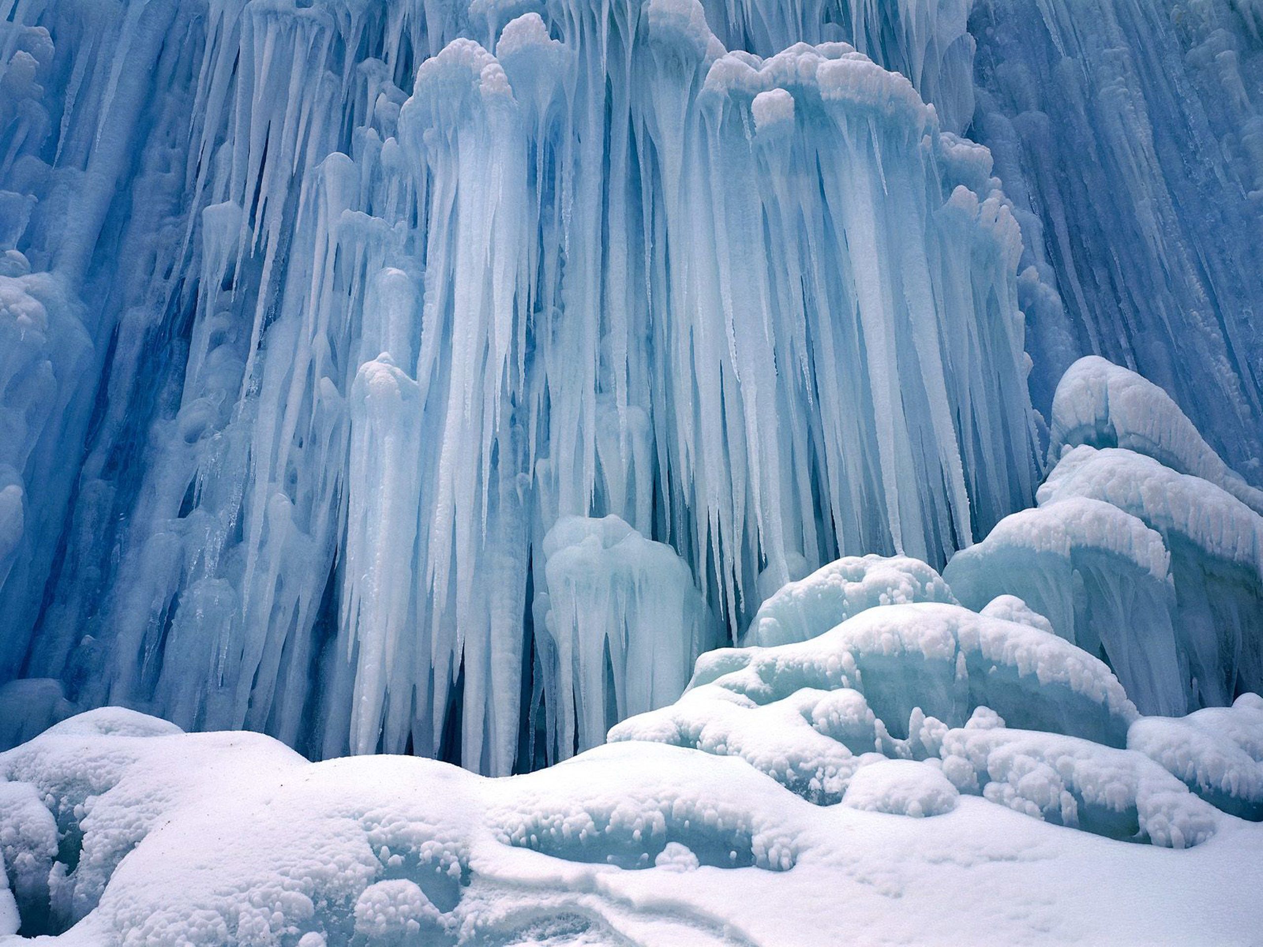 A large ice formation on the side of snow - Ice