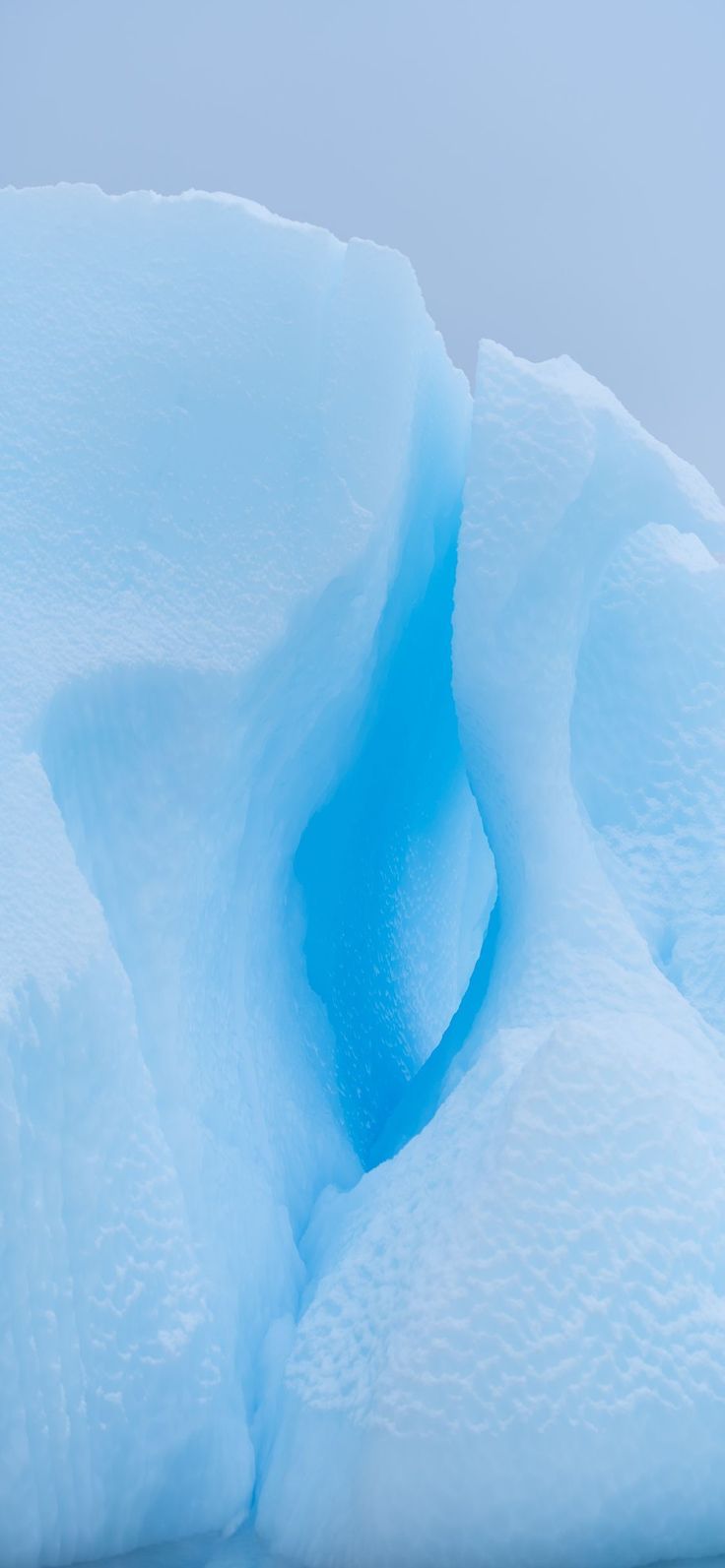 An iceburg with a hole in it that looks like a heart. - Ice