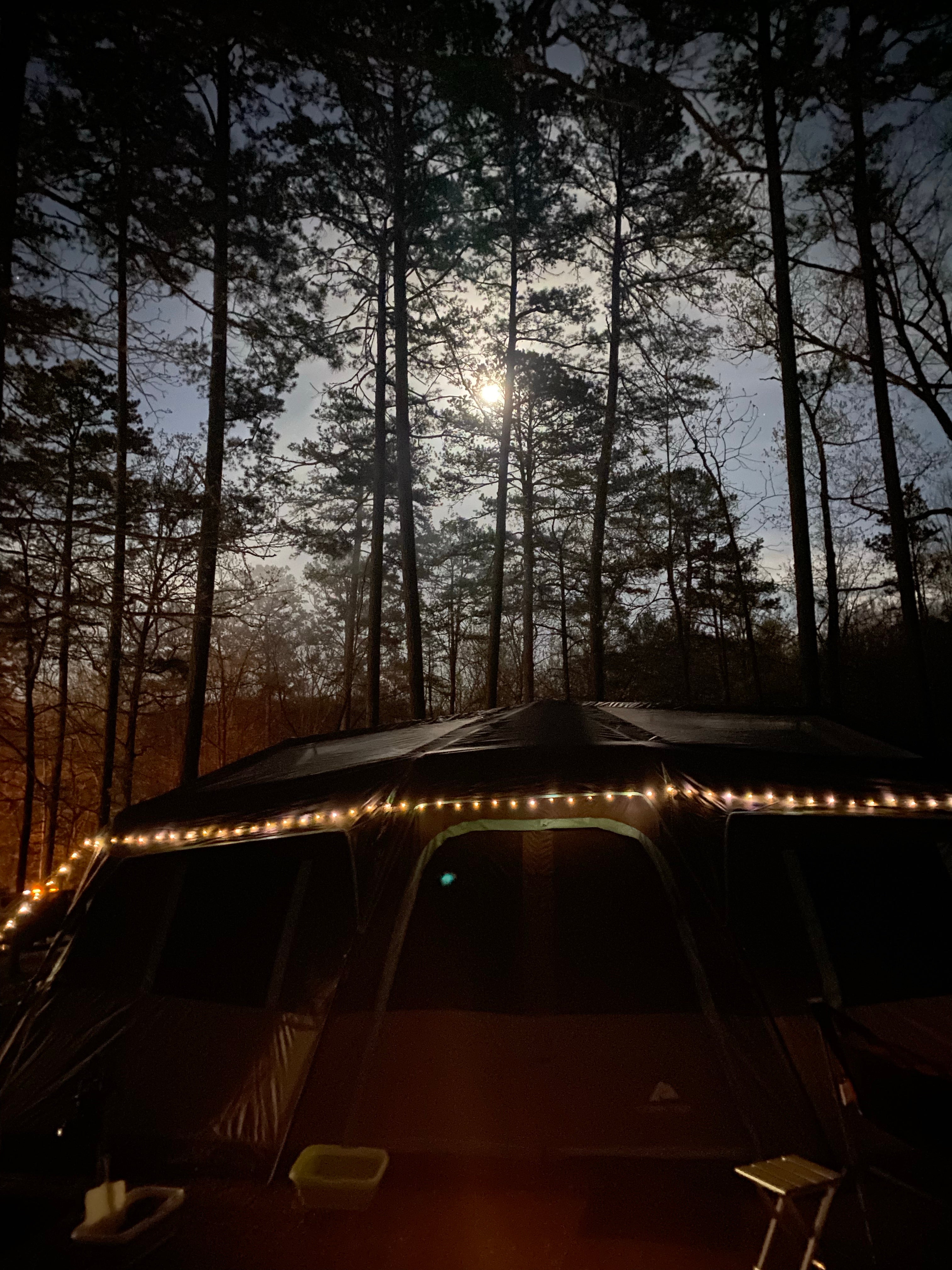 The inside of a tent with fairy lights on the ceiling - Camping