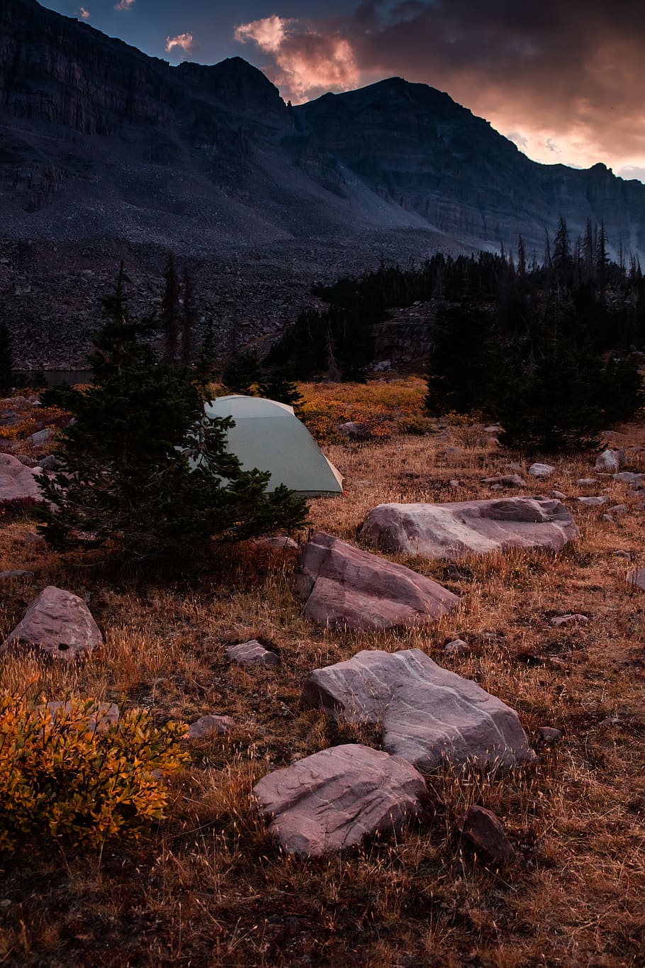 A tent is set up in the middle of some rocks - Camping
