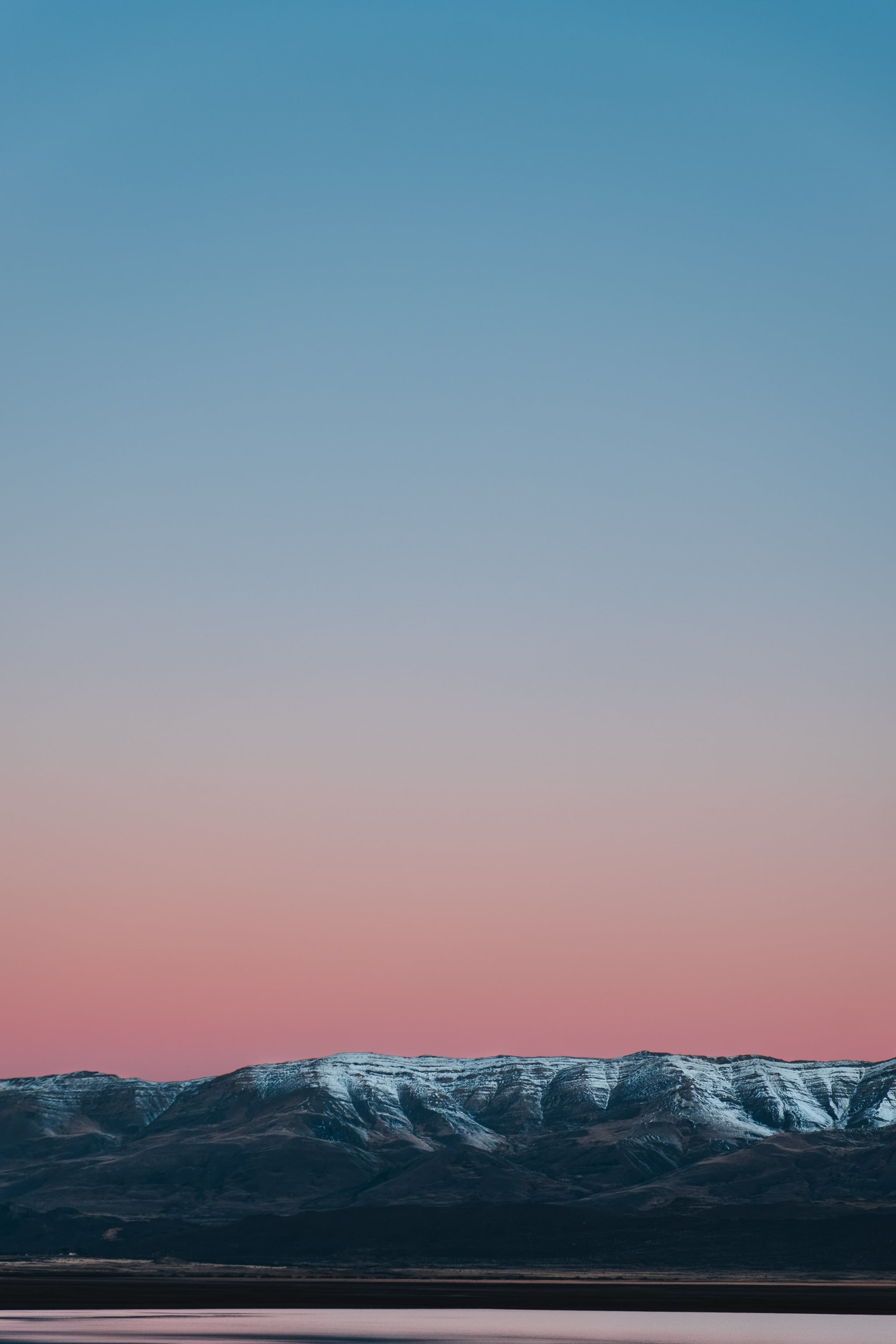 A beautiful image of a snow capped mountain with a pink and blue sky. - Calming