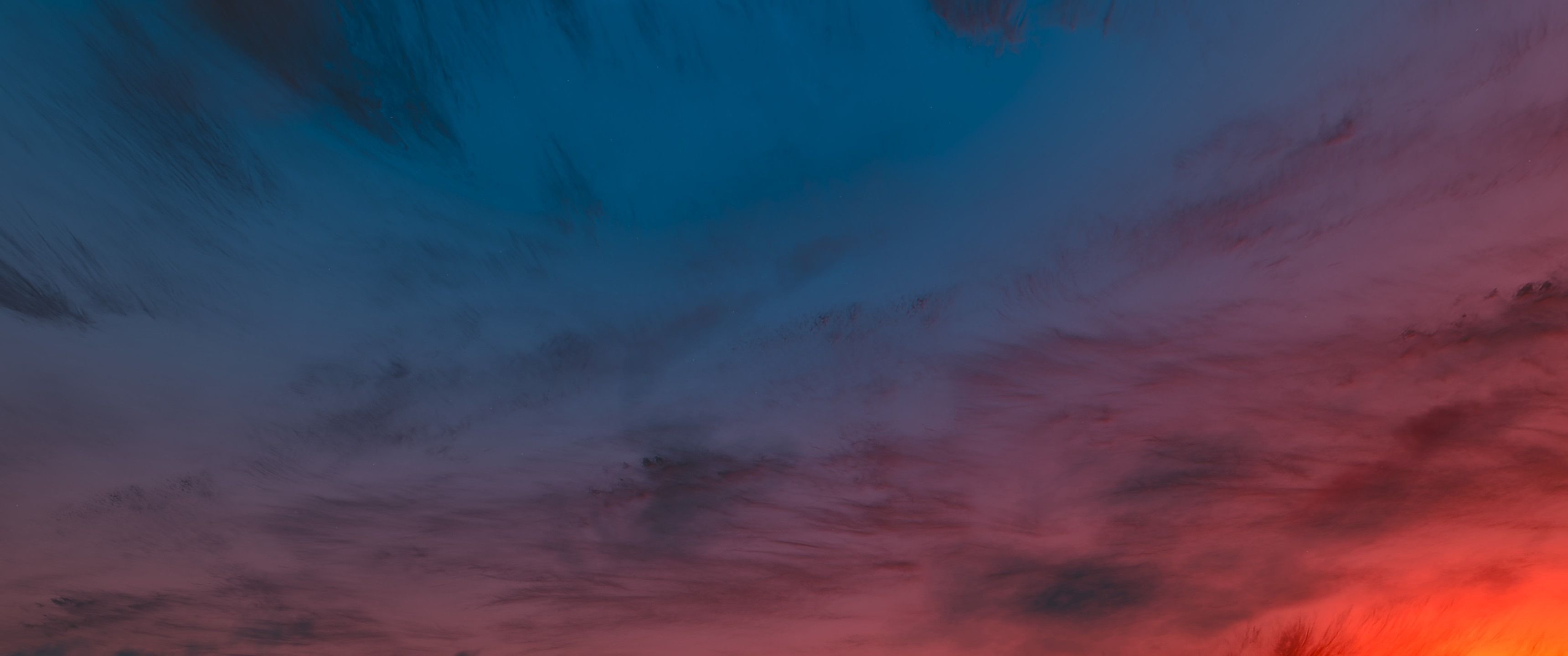 A photo of a sky with clouds during sunset - 3440x1440