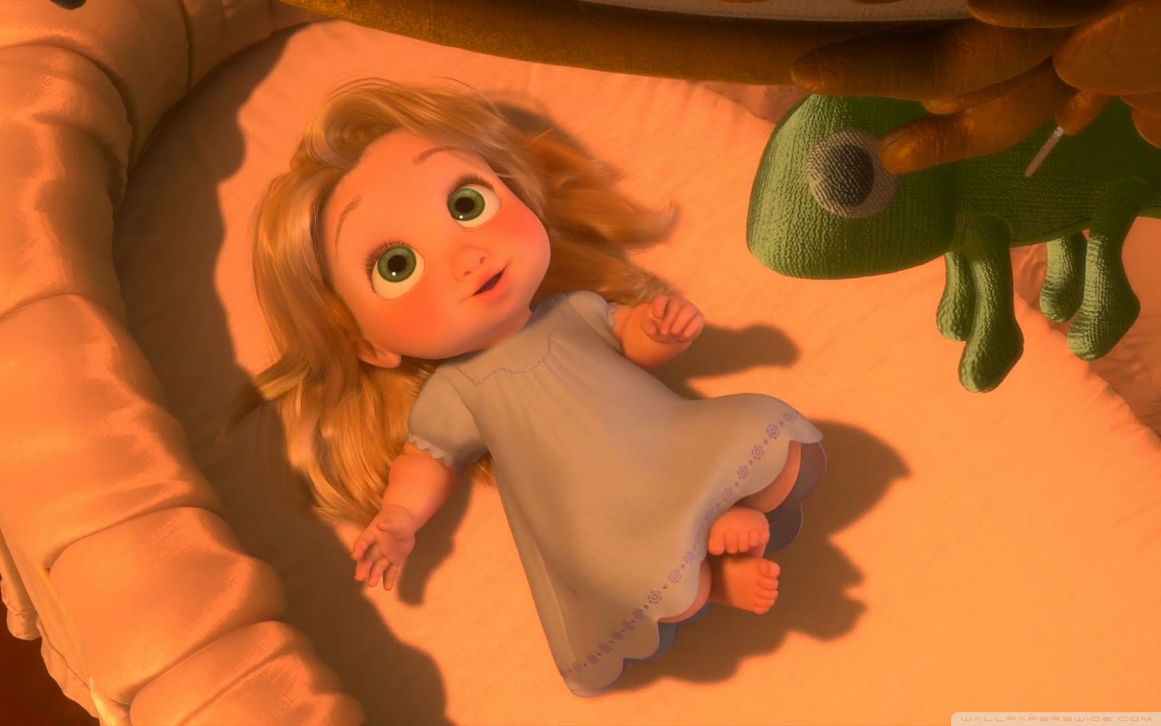 A baby girl laying in her crib next to an animated character - Rapunzel