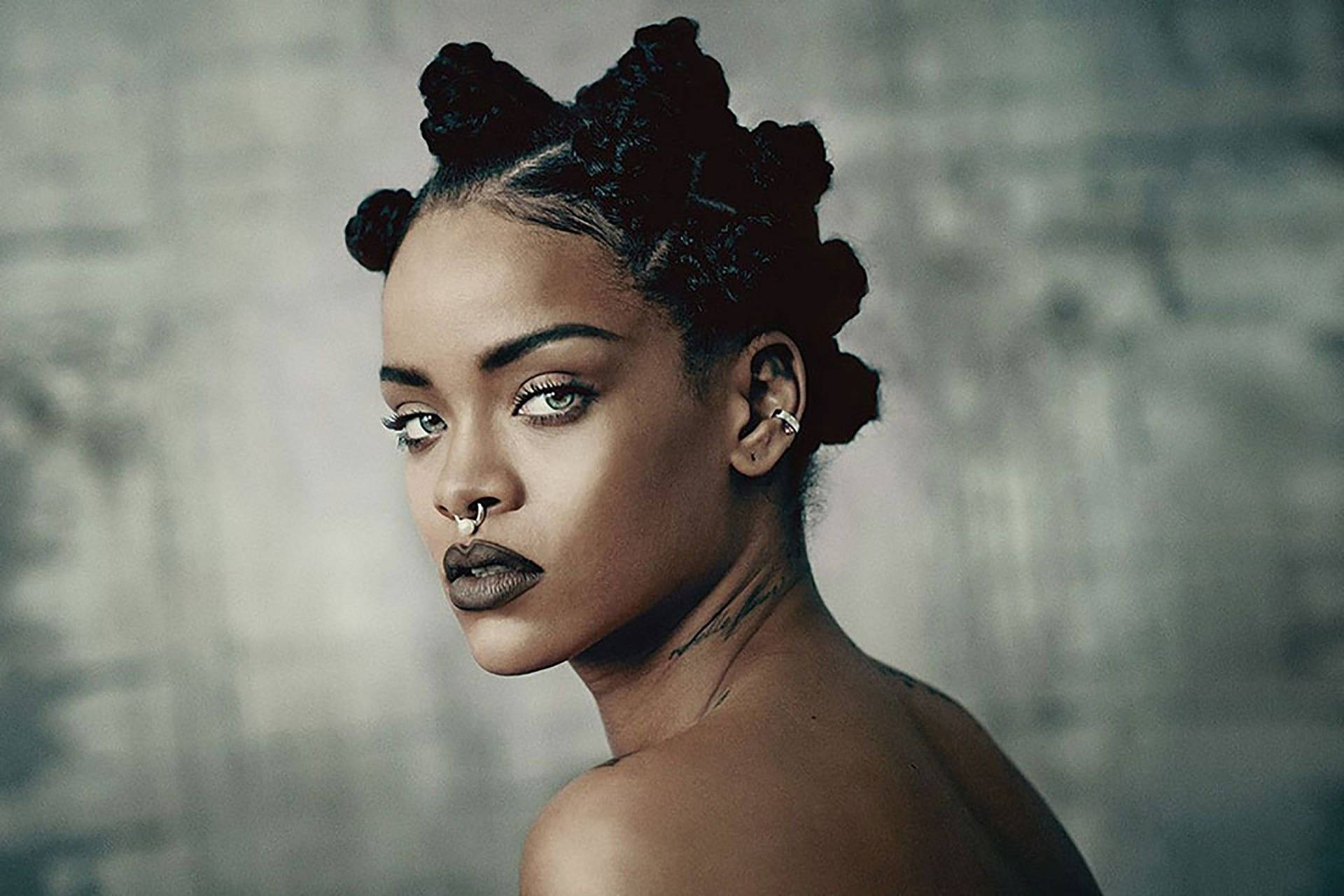 A close up of Rihanna with a nose ring and dark lipstick - Rihanna