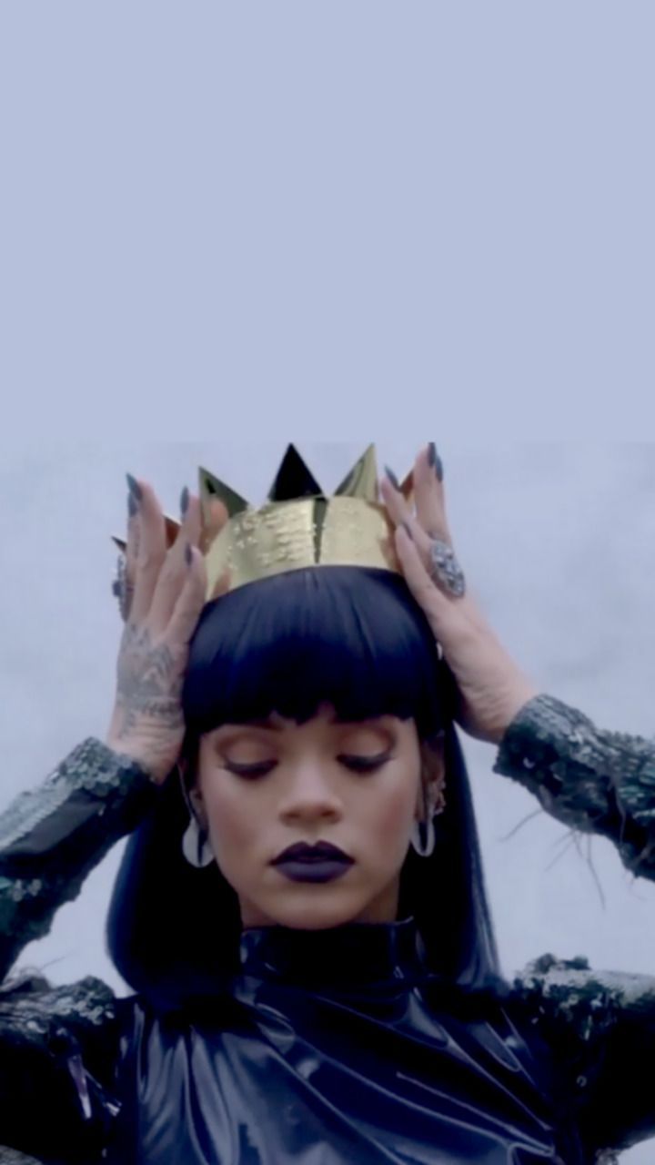A woman with black hair and a crown on her head. - Rihanna