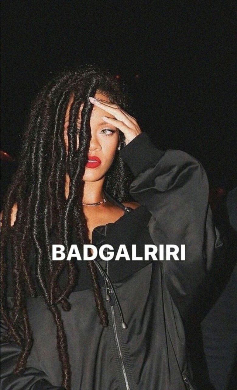 A woman with dreadlocks covering her face - Rihanna