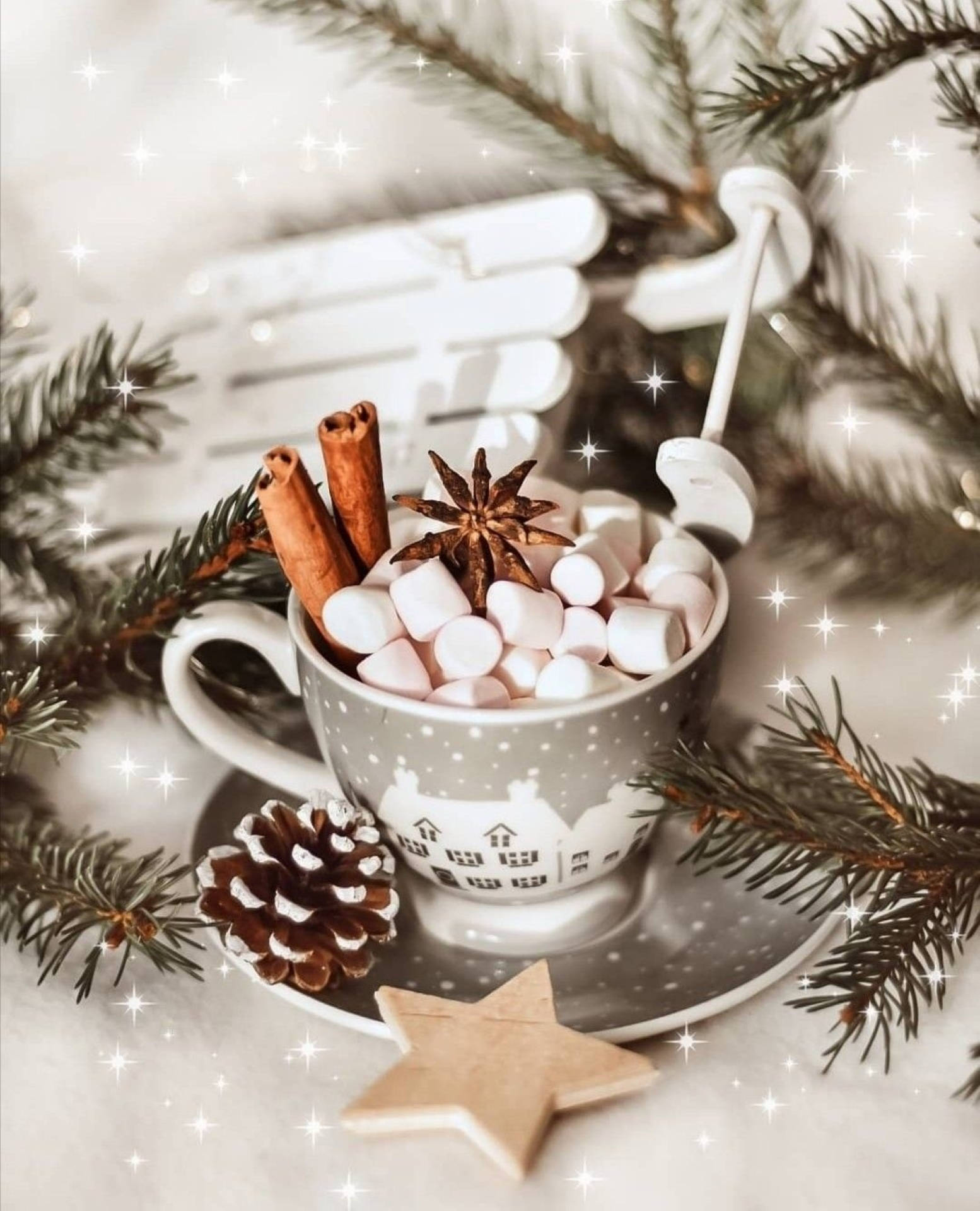 A cup of hot chocolate with marshmallows, cinnamon sticks, and a pine cone. - White Christmas, cute Christmas