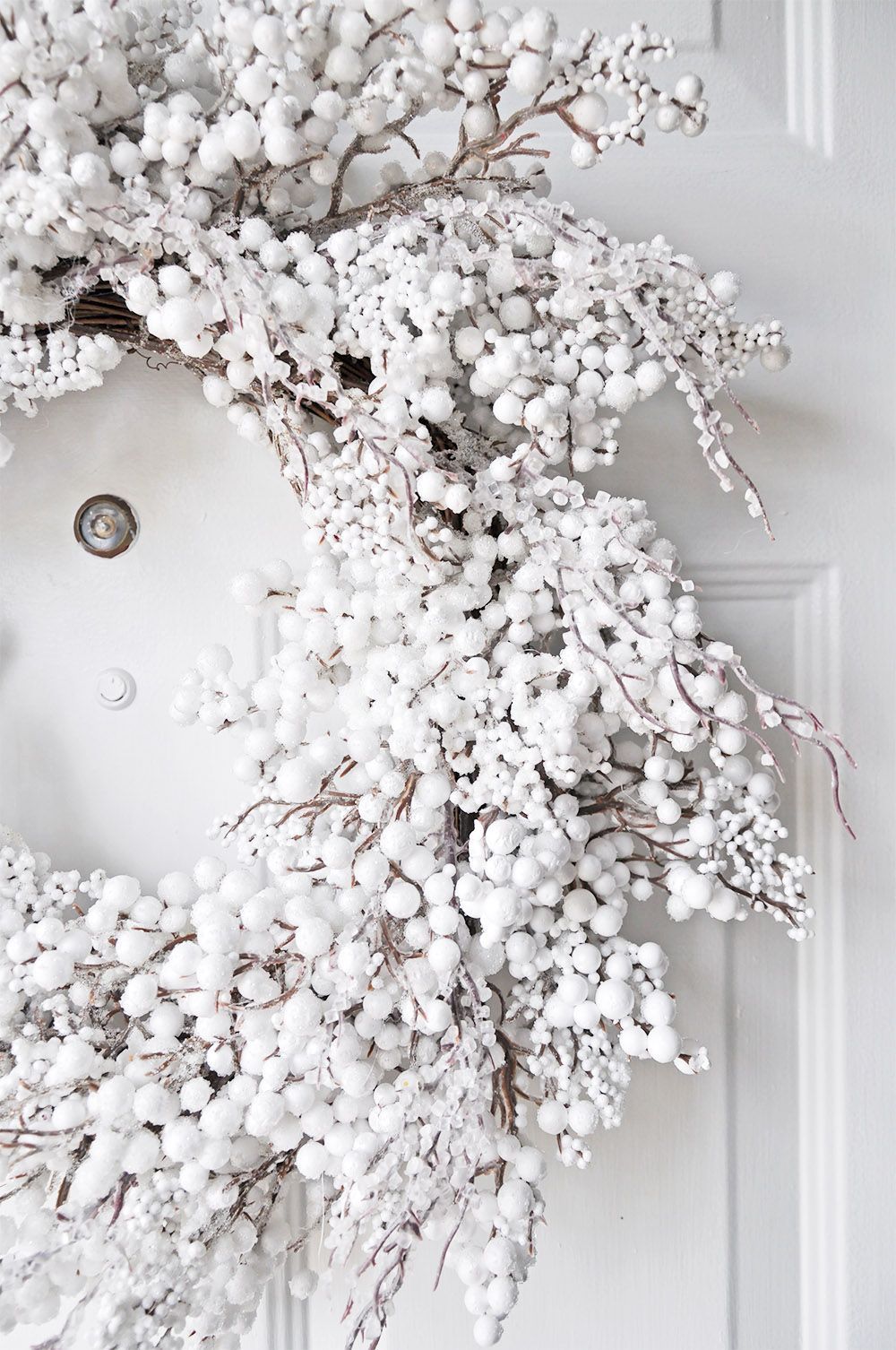 A wreath made of white berries and branches - White Christmas