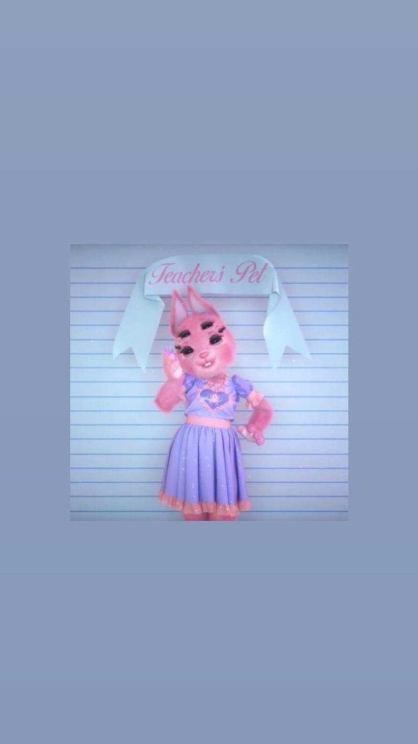 A pink stuffed animal with an image of the character on it - Melanie Martinez