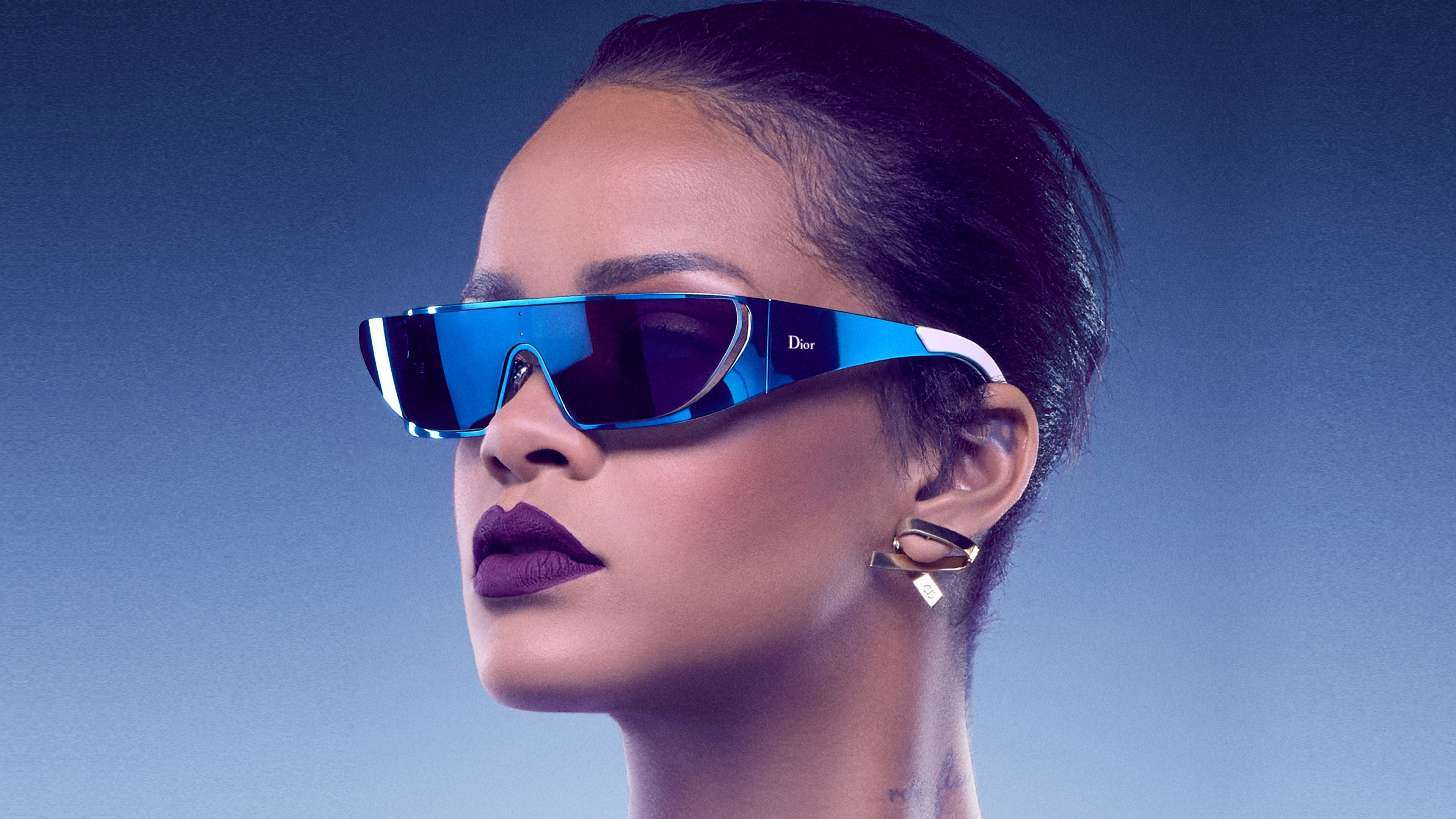 A woman wearing sunglasses and lipstick - Rihanna, Dior