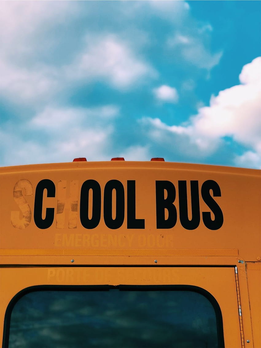 A yellow school bus with black lettering on it - School