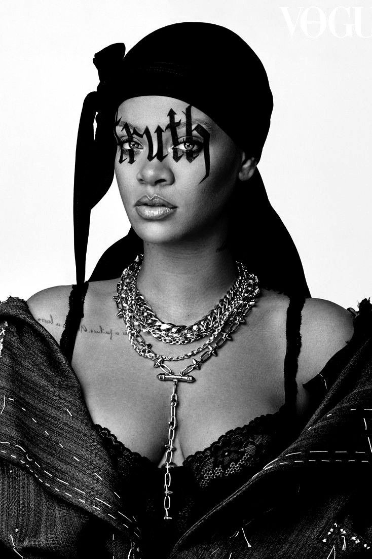 A woman with her face covered in black and white - Rihanna