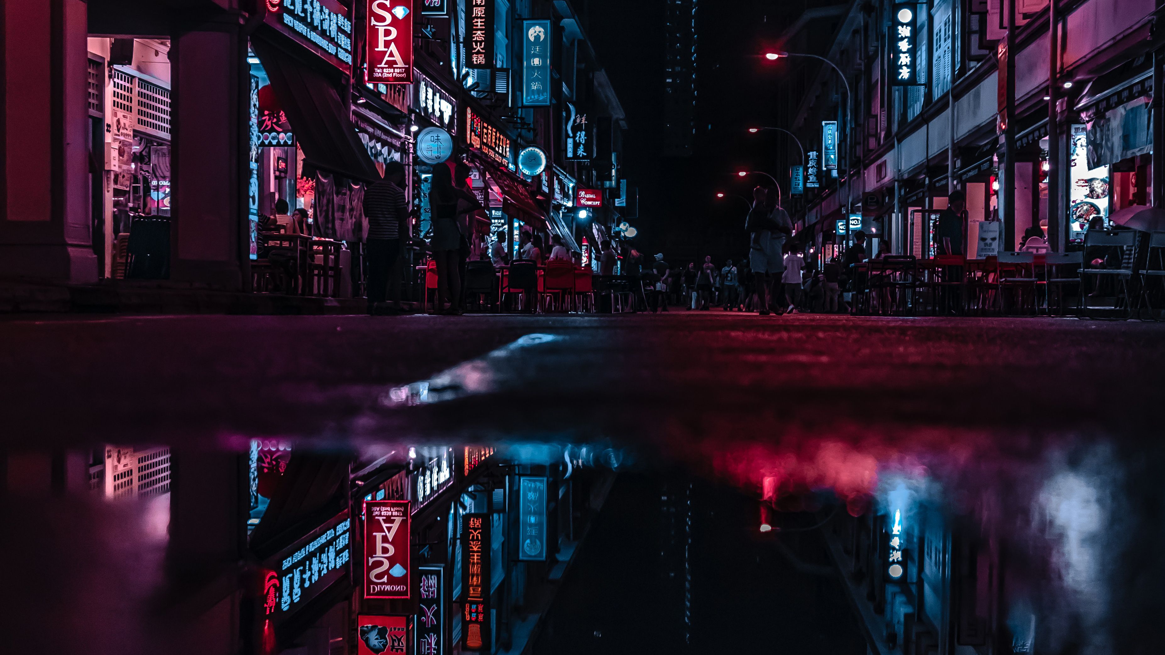 A city street at night with neon lights - City