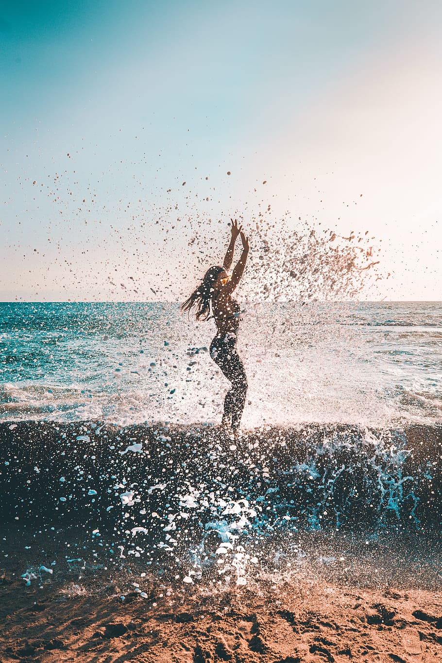 HD wallpaper: woman jumping on seashore during daytime, ocean, adventure, sunset