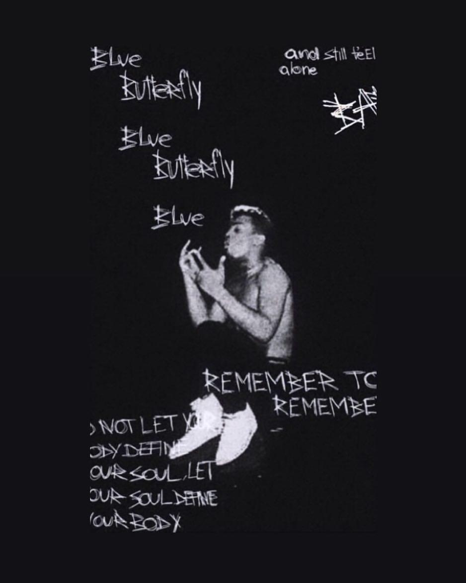 A black t-shirt with a man in a white shirt holding a blue butterfly. - XXXTentacion