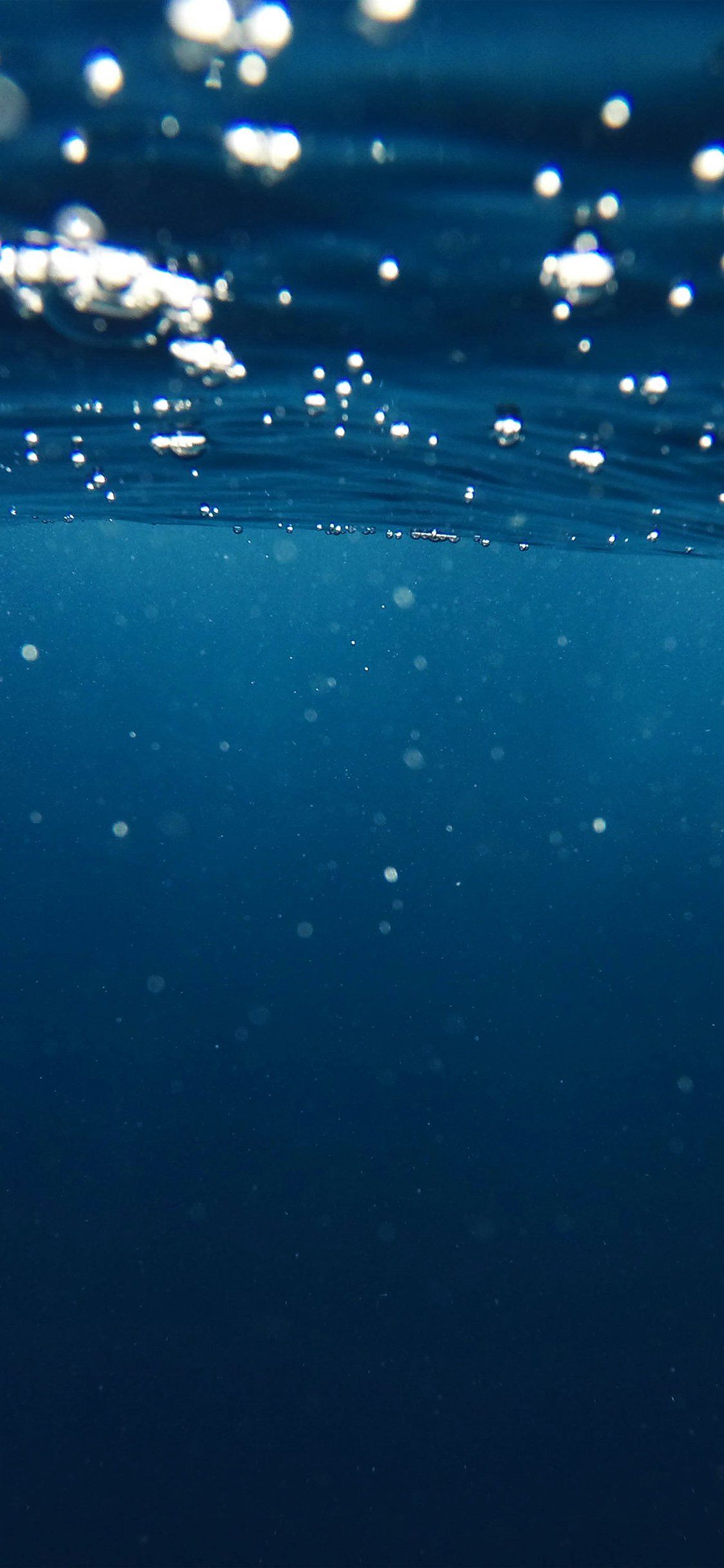 The surface of the water is filled with bubbles - Underwater