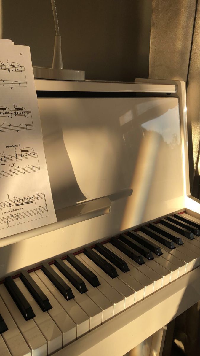 A piano with sheet music on top of it - Piano