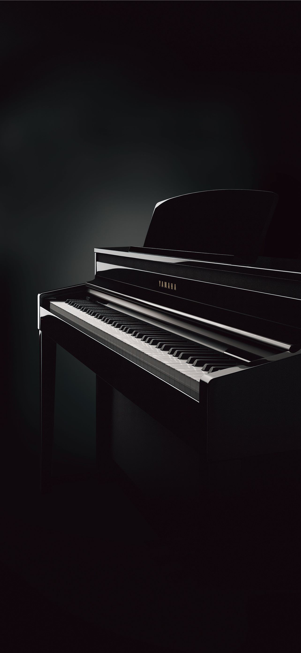 A black piano sitting in the dark - Piano