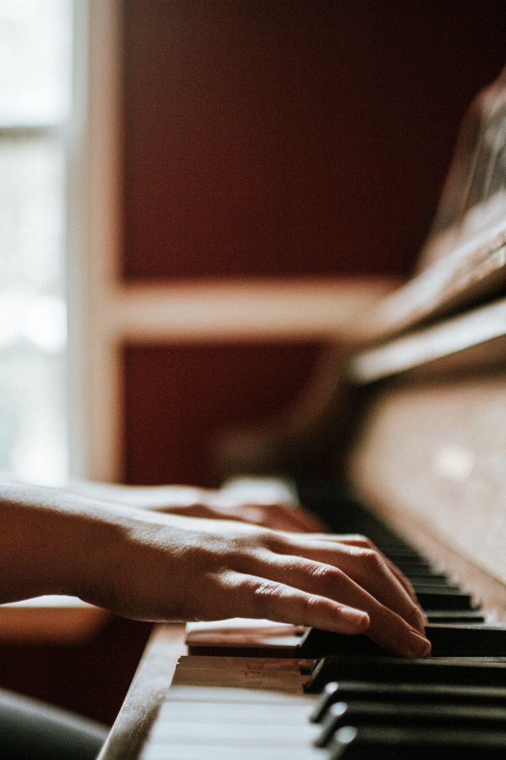 A person's hands playing the piano. - Piano