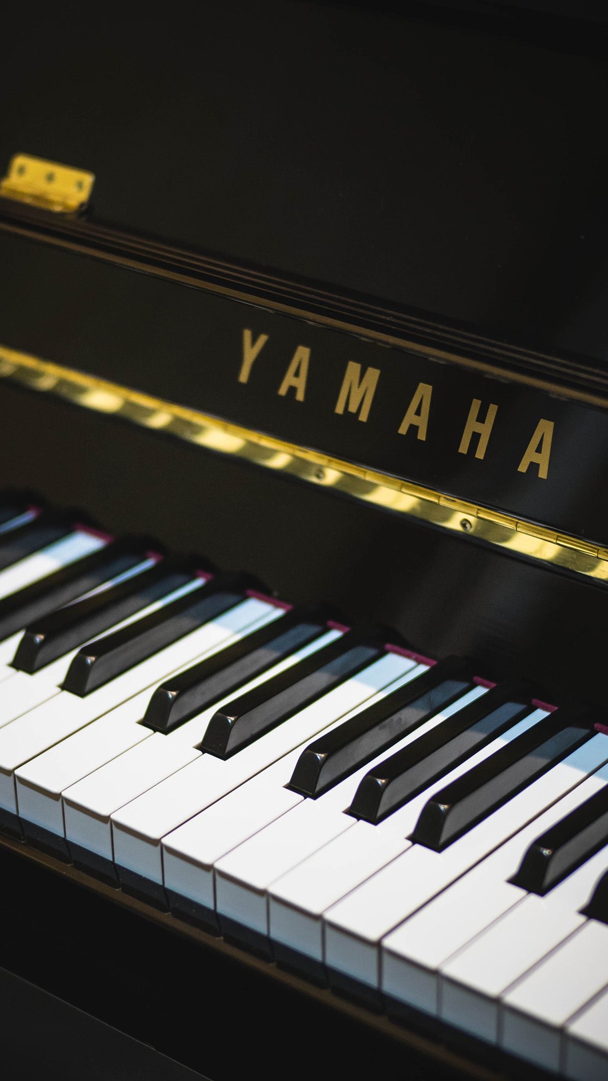 A close up of a Yamaha piano keyboard. - Piano