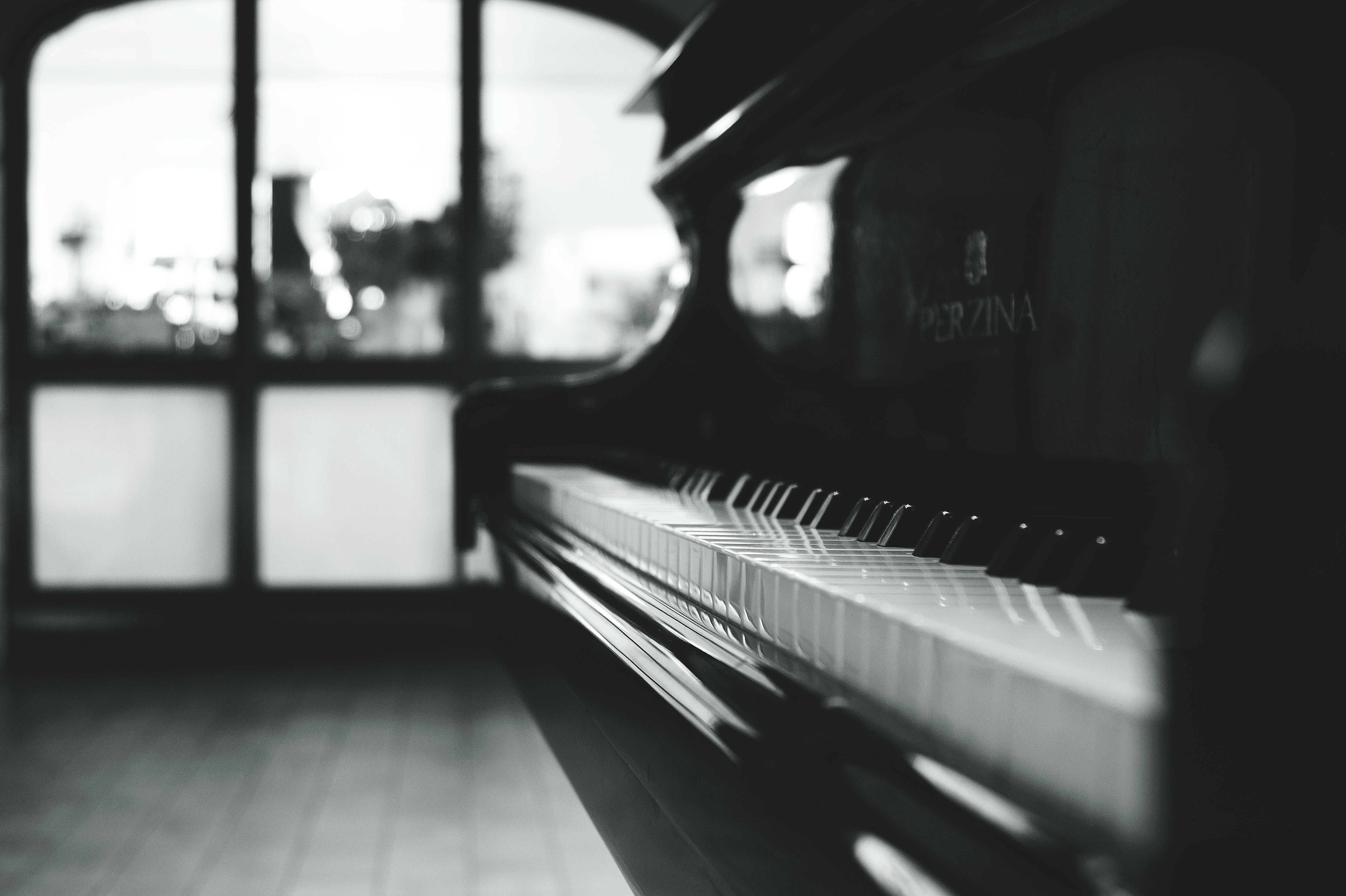 A black and white photo of a piano. - Piano