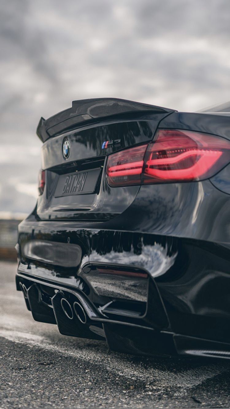 A black bmw car parked in the street - BMW