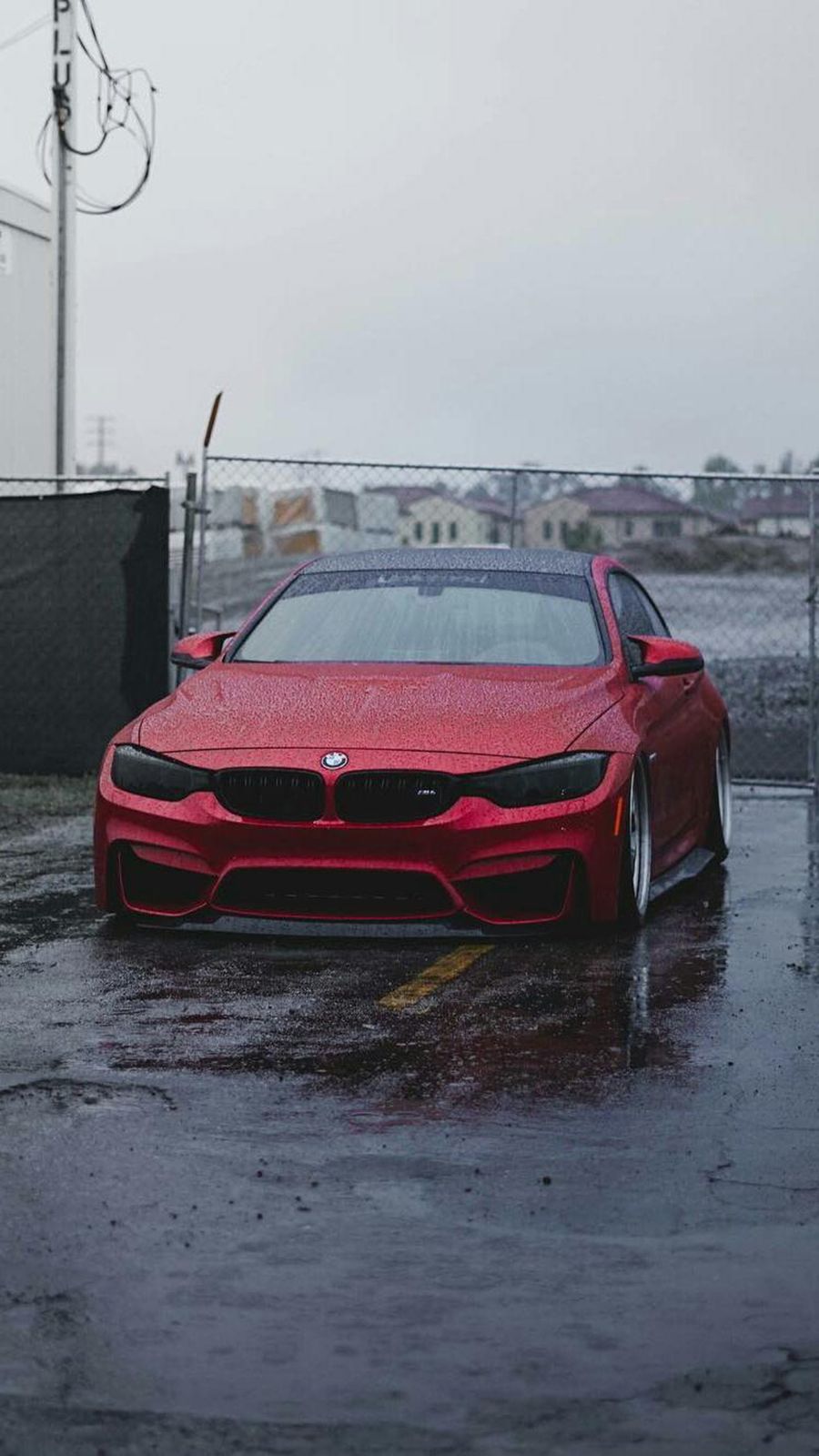 A red car parked in the rain - BMW