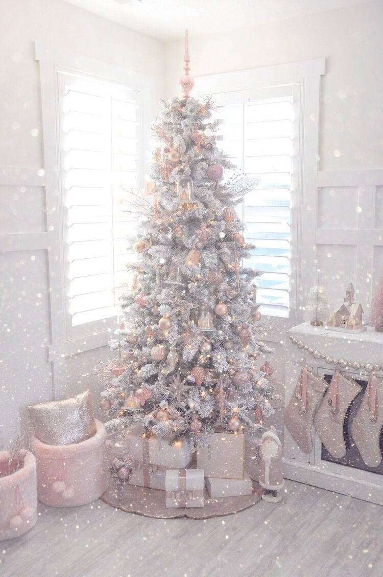 A white Christmas tree with pink and silver ornaments, surrounded by presents in a white room. - Cute Christmas