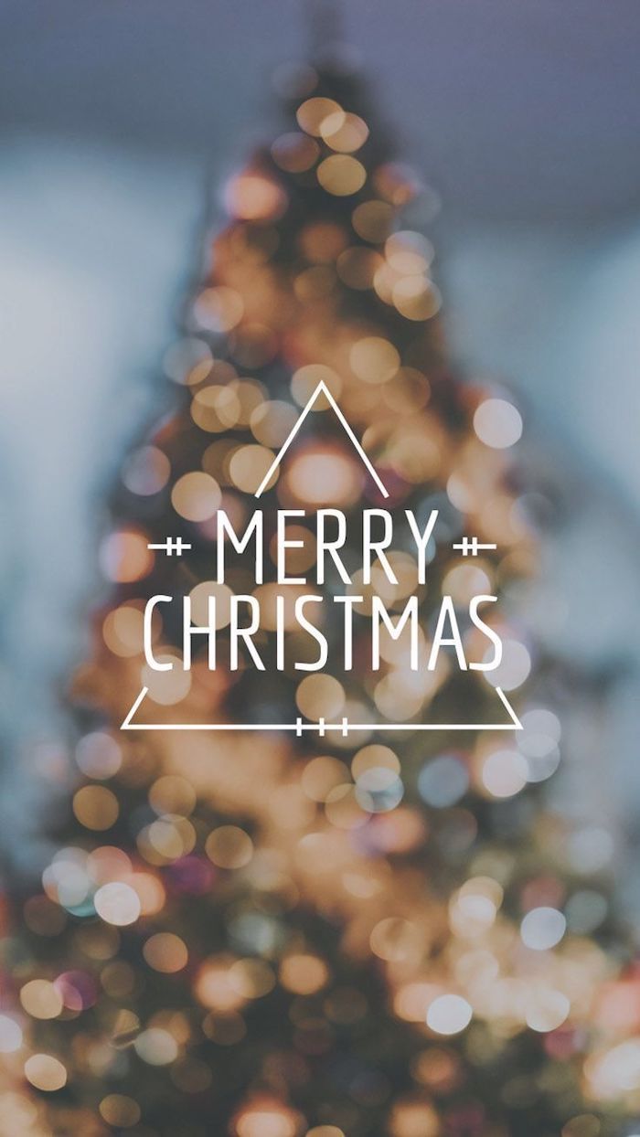 Merry christmas written in white, on a blurry background, featuring a blurred christmas tree, christmas wallpaper iphone - Cute Christmas