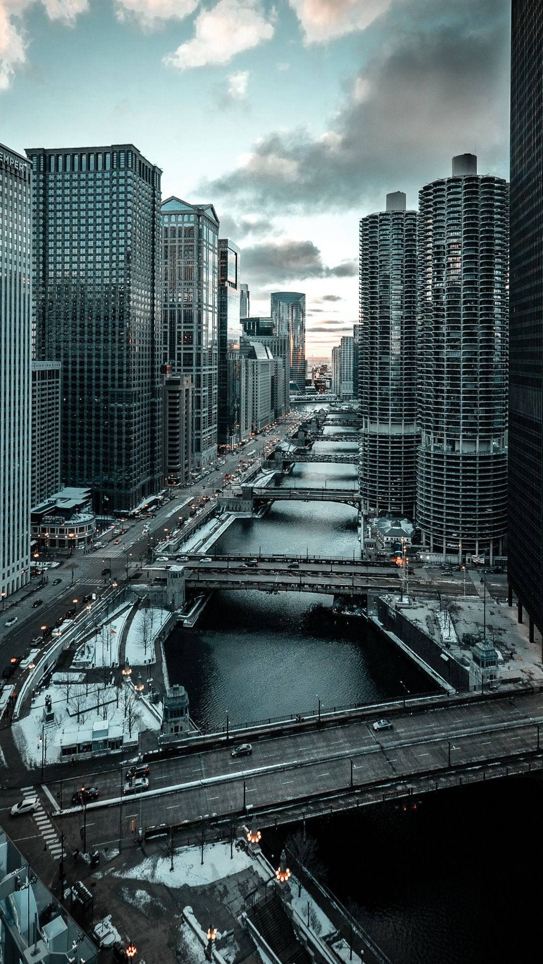 A cityscape with tall buildings and a river - Chicago